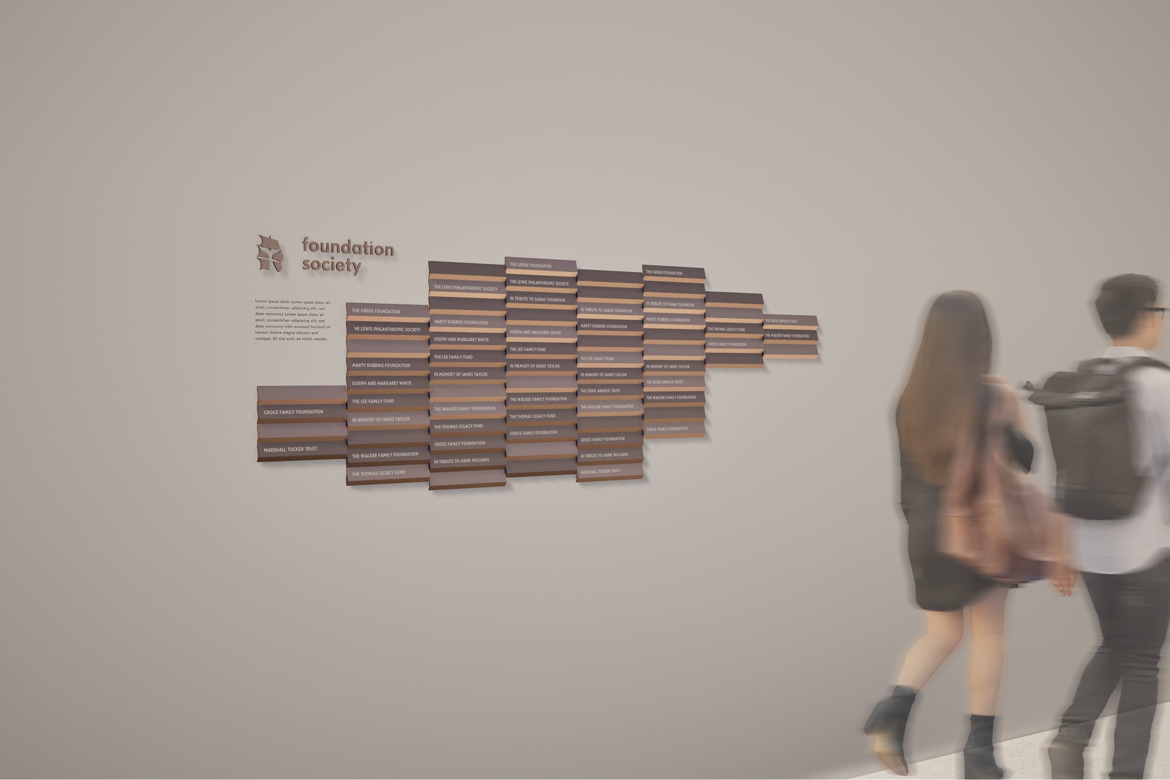Stepped, staggered donor recognition wall with wood-toned name plaques cascading in a diagonal ascending pattern beneath a "Foundation Society" logo, donor wall signage by RSM Design