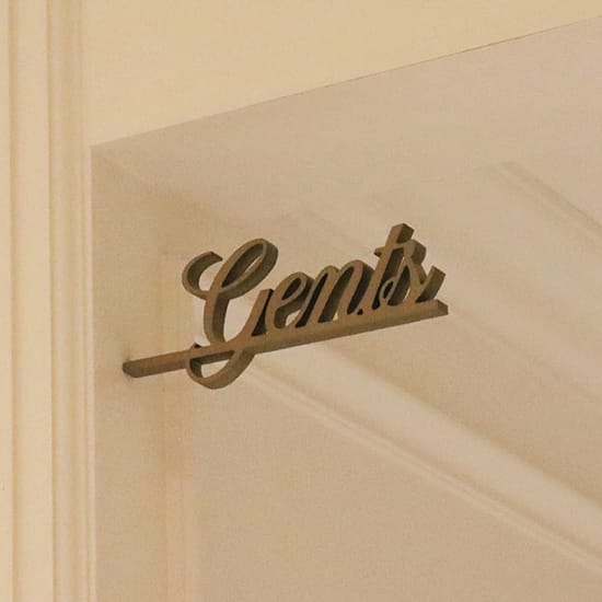 Dimensional script "Gents" sign mounted above a doorway at The Swexan Hotel - environmental graphic design by RSM Design