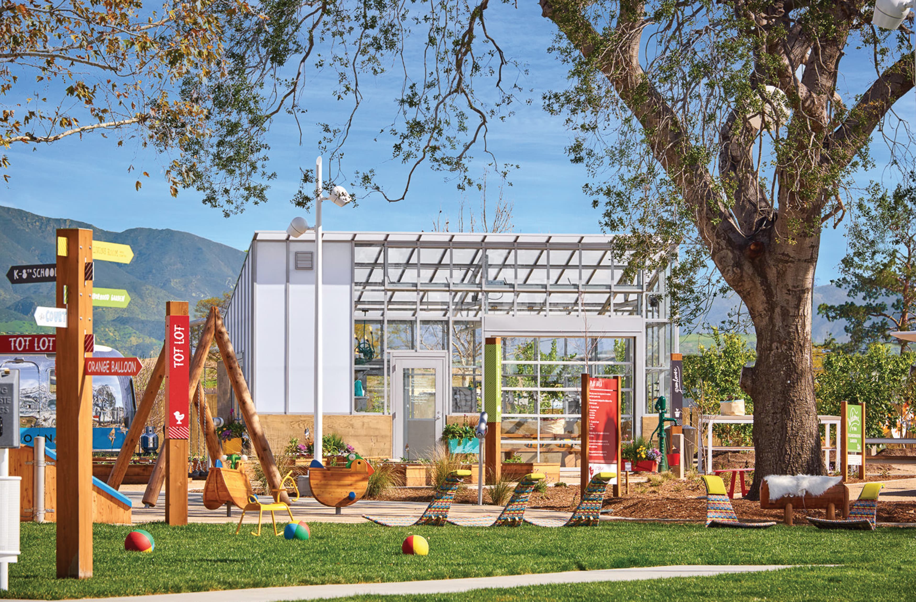 A playground for all ages of kids with colorful placemaking elements and wayfinding signage to direct visitors