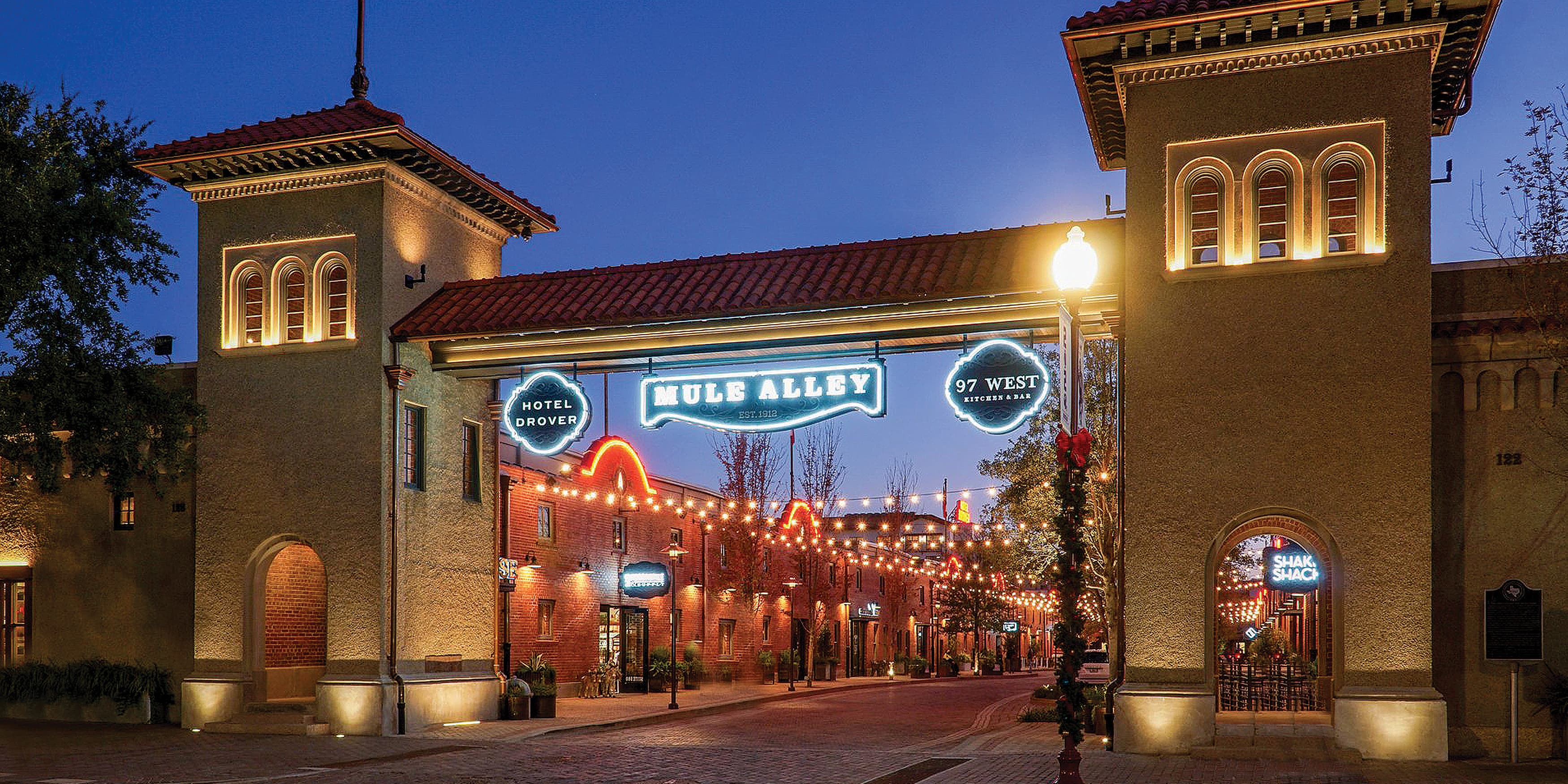 Nightime exterior shot of The Drover Hotel in Fort Worth, Texas overhead identity