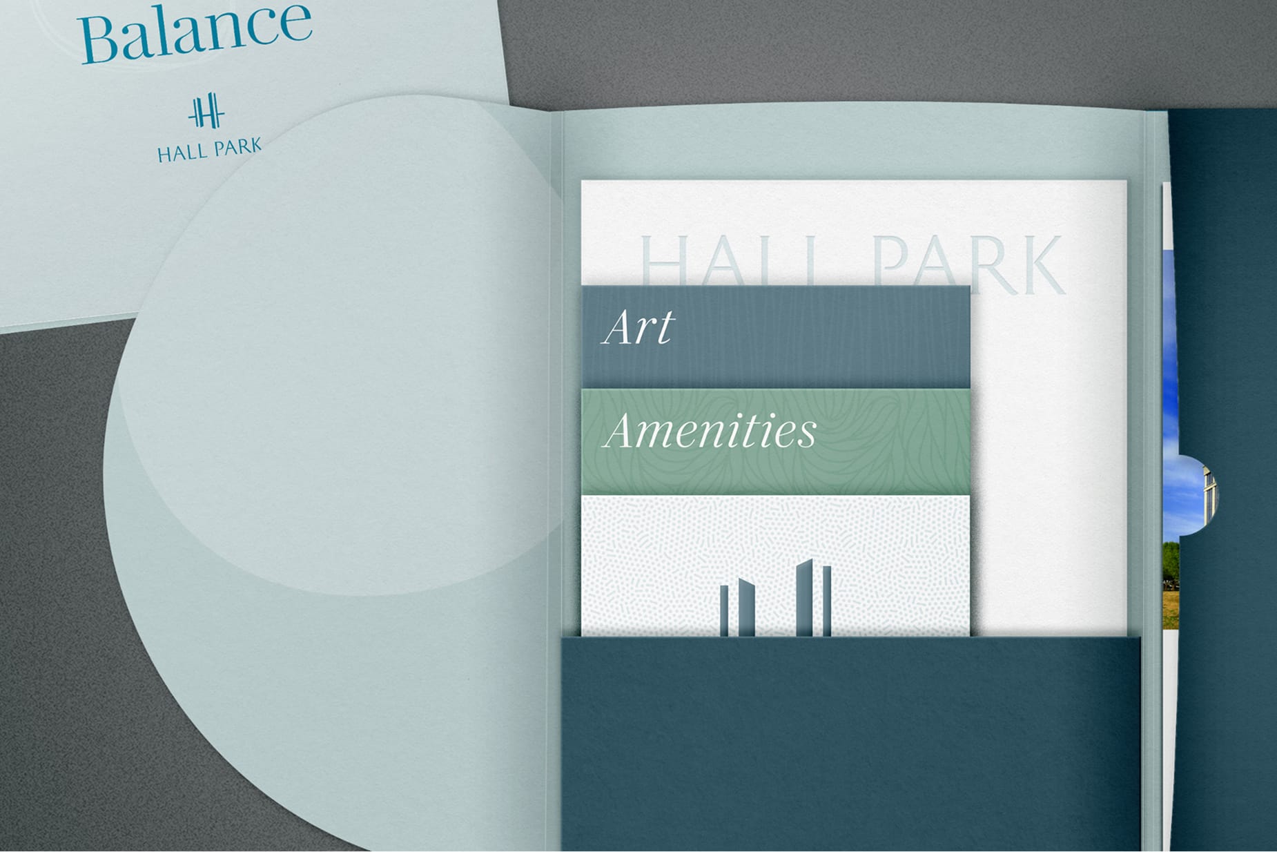 Presentation folder holding a set of Art and Amenities booklets alongside a "Balance" branded insert for Hall Park - brand identity and print collateral by RSM Design