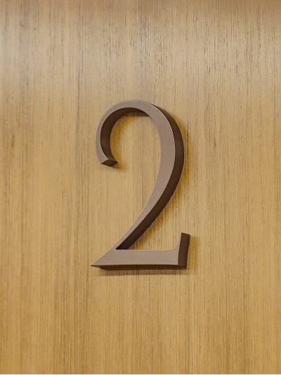 Custom Art Deco numeral "2" on a wood-paneled wall at Maple Terrace - environmental graphic design by RSM Design