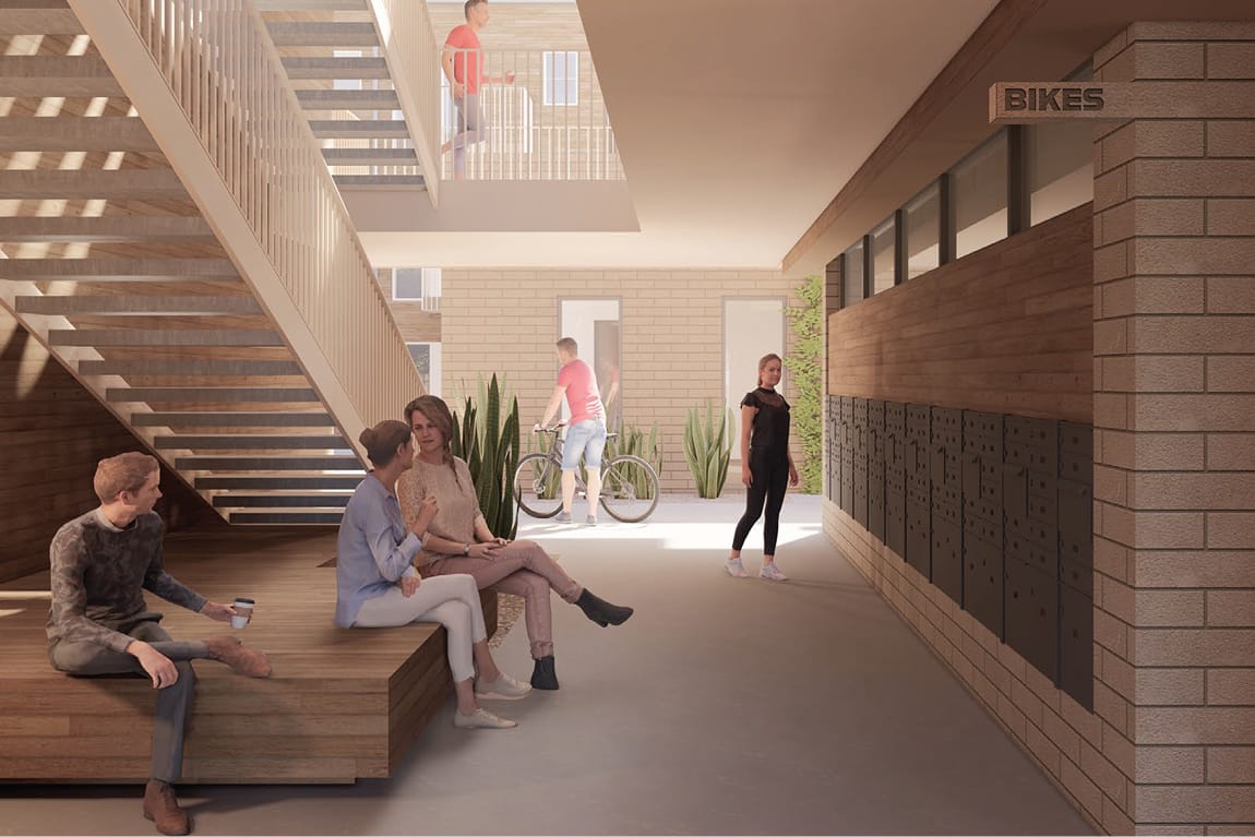 Interior rendering of the Bloc House common area, showing a double-height lobby with an open-tread wood staircase and upper walkway. Residents sit and chat on a wood bench in the foreground while another wheels a bicycle toward a sunlit exit. A wall of individual package lockers lines the right side beneath a "Bikes" sign, with warm brick, wood paneling, and potted snake plants completing the space.
