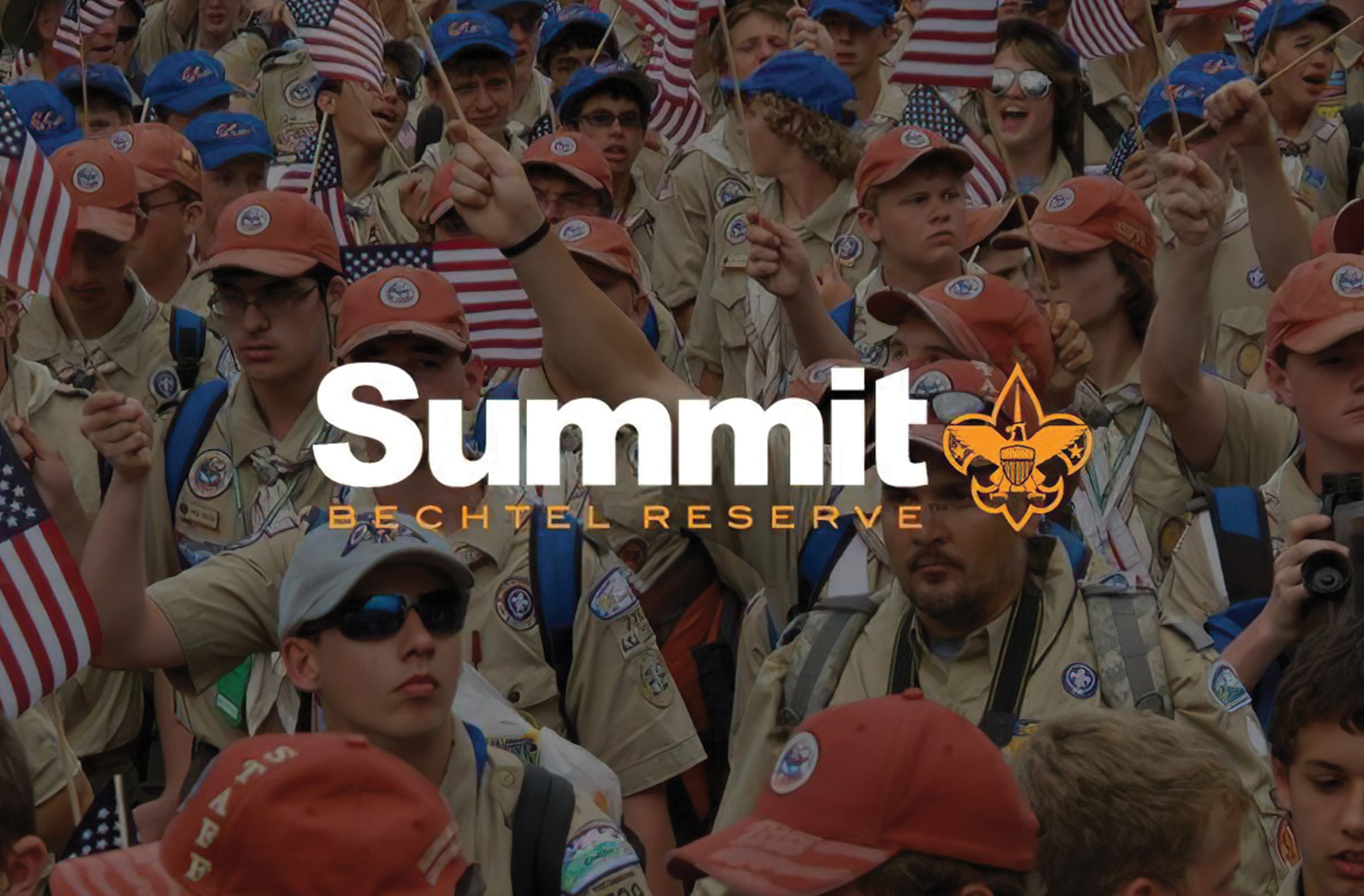 The logo for Summit Bechtel Reserve overlaid on an image of Scouts with American flags.