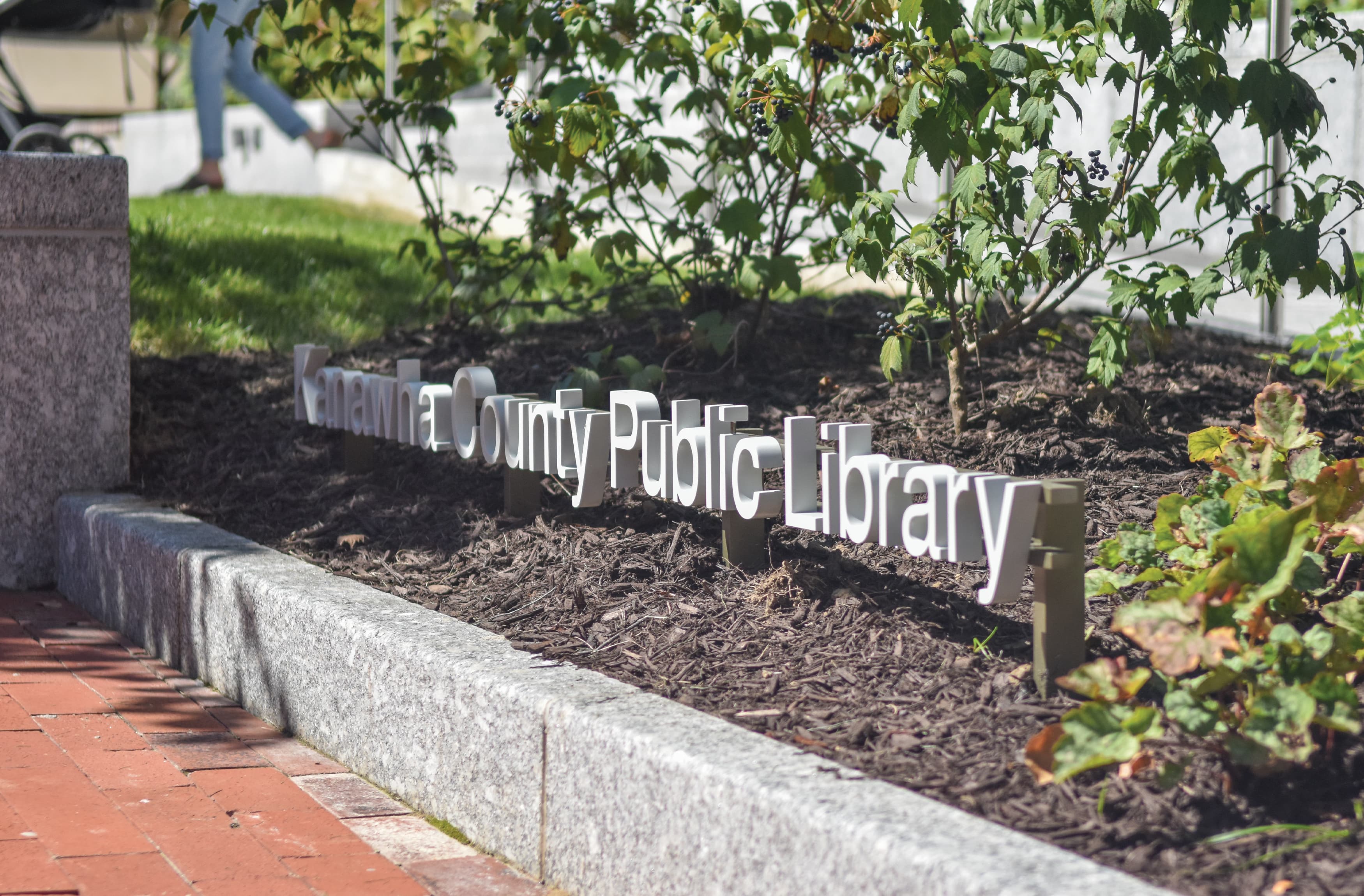 Planter pedestrian signage for Kanawha County Public Library. White lettering pedestrian signage by RSM Design. 