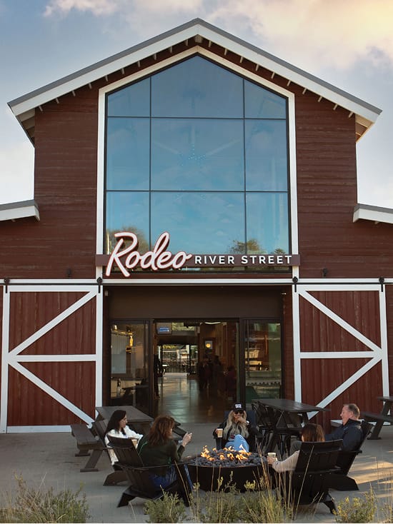 River Street Marketplace Rodeo River Street barn entrance with fire pit seating, environmental graphic design by RSM Design