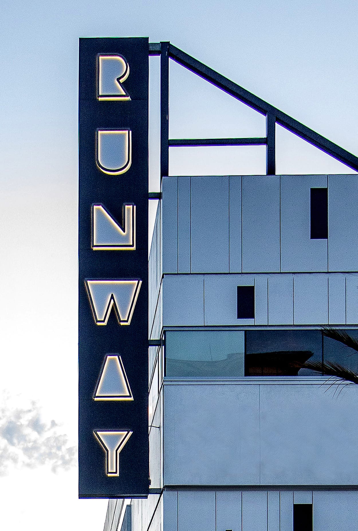 Vertical Runway sign integrated into the architecture at Runway Playa Vista in Los Angeles, part of the district’s branding and environmental graphics program designed by RSM Design.