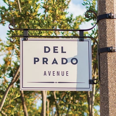"Del Prado Avenue" street sign mounted on a decorative iron bracket in Dana Point - environmental graphic design by RSM Design