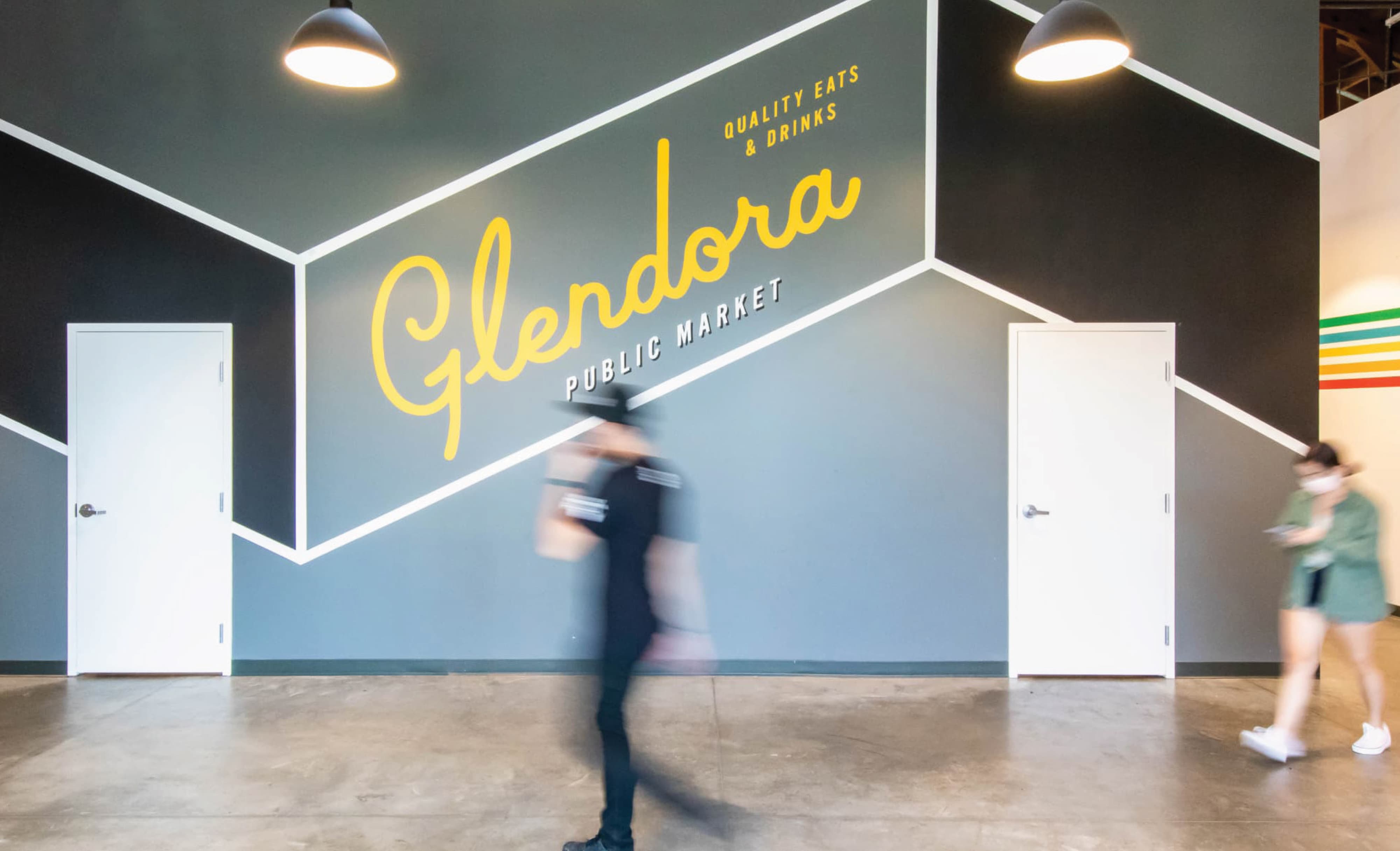 Interior feature wall at Glendora Public Market showcasing environmental graphic design, branded typography, and integrated wayfinding, supporting brand identity, placemaking, and user experience within a retail and hospitality mixed-use destination by RSM Design