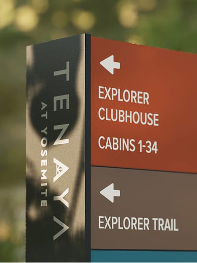 Tenaya at Yosemite wayfinding totem sign directing guests to Explorer Clubhouse, Cabins 1–34, and Explorer Trail