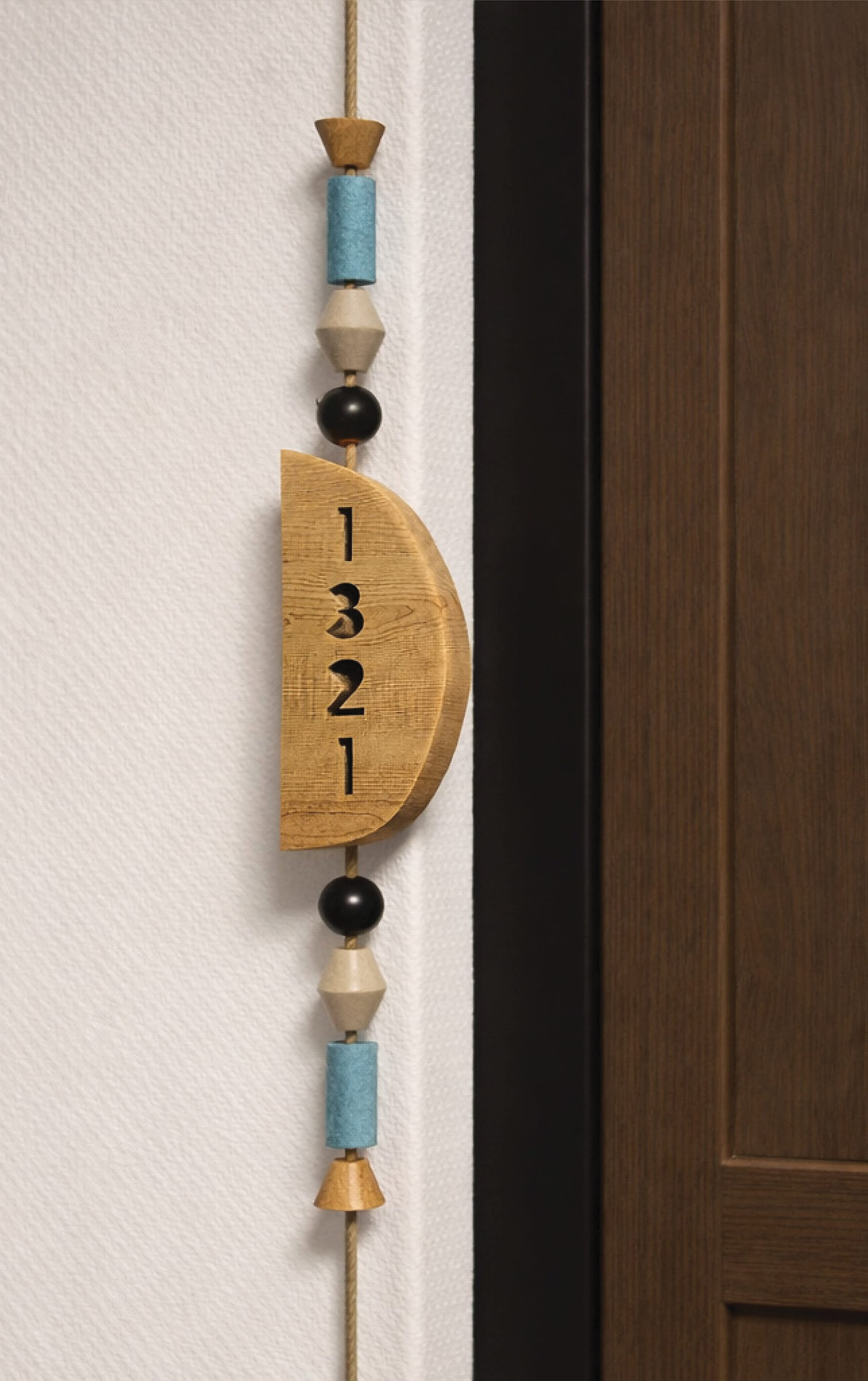 Custom wood room number plaque with handcrafted detailing, showcasing environmental graphic design, branded signage, and wayfinding for hospitality, residential, and mixed-use environments.