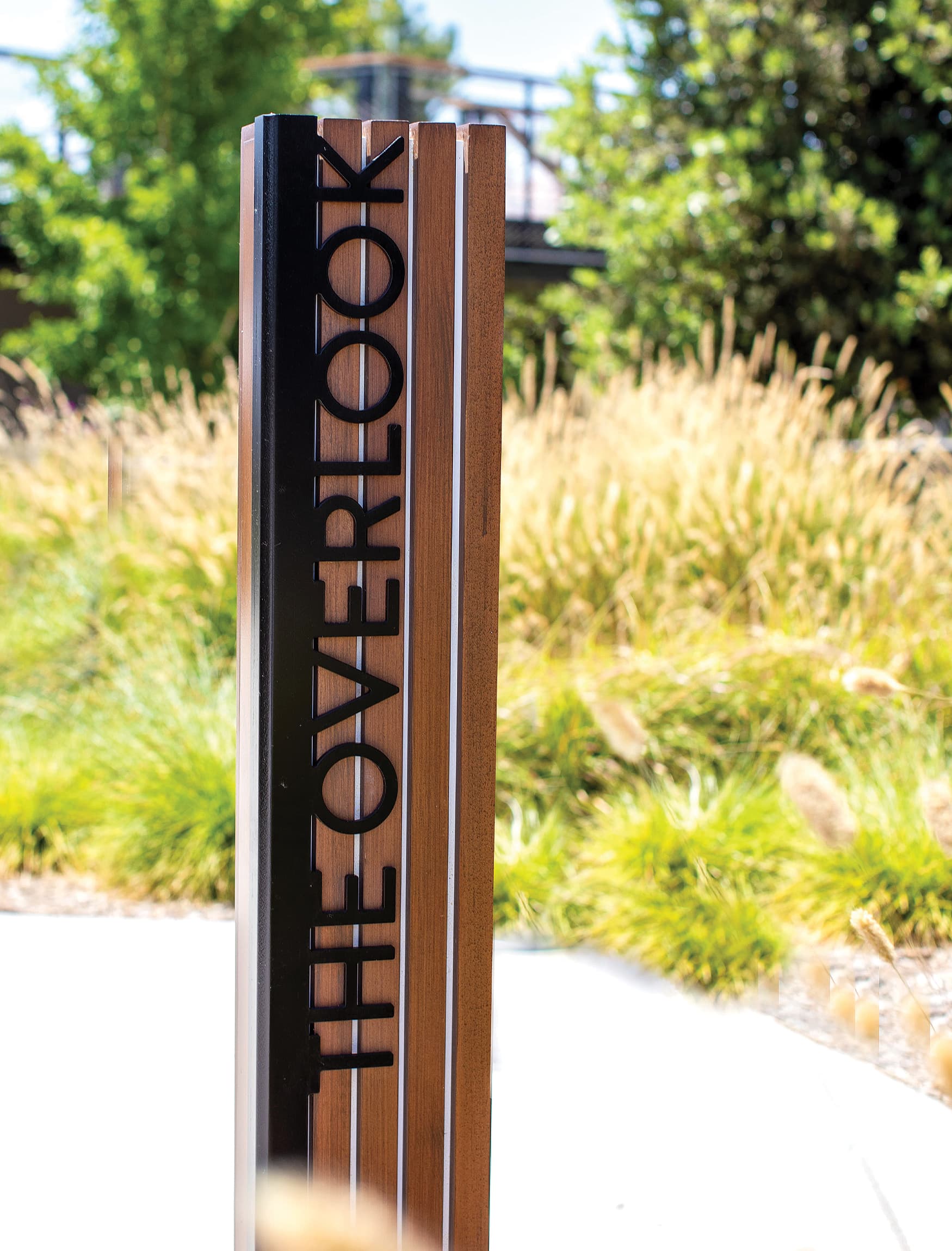 Pedestrian wooden vertical sign for Rise Park in Irvine, California.
