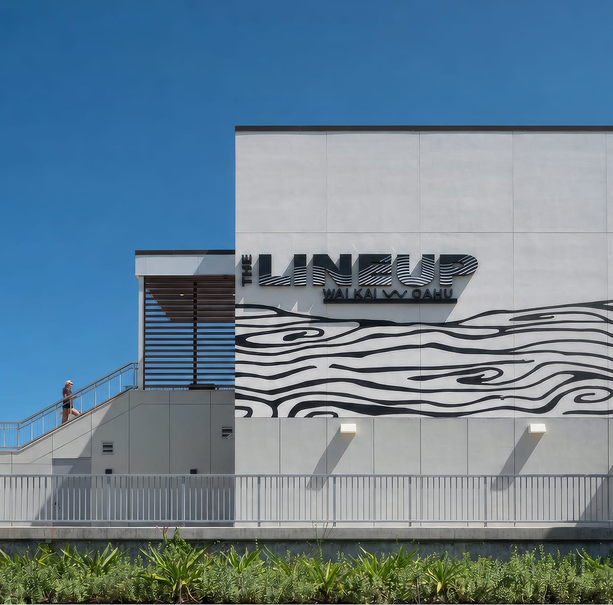 "The Lineup" building facade signage with graphic wave mural at Wai Kai, Ewa Beach, Oahu, environmental graphic design by RSM Design.