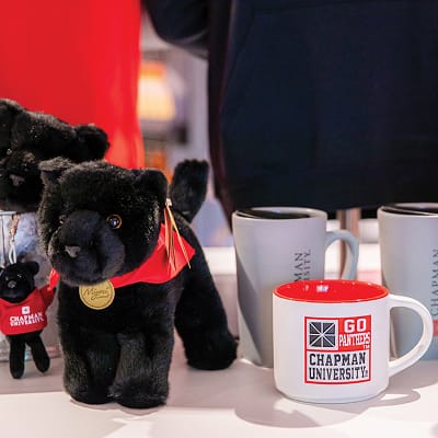 RSM Design Chapman University Rinker Campus Center Irvine — Chapman University Panther Store merchandise display featuring branded campus mugs and panther mascot plush toys in Panther Store retail environment