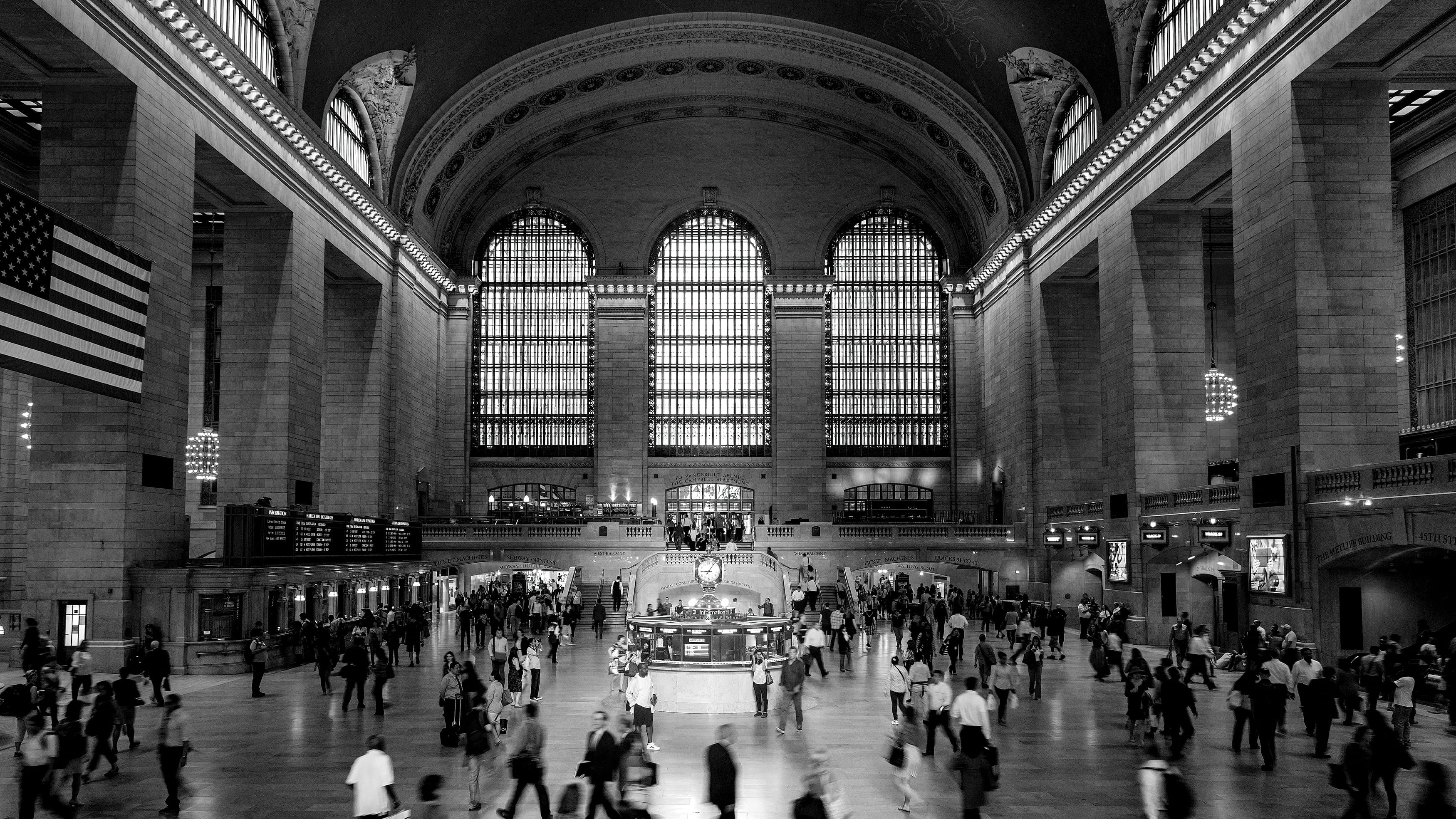Black and white image of people walking through Grand Central Terminal in New York City
