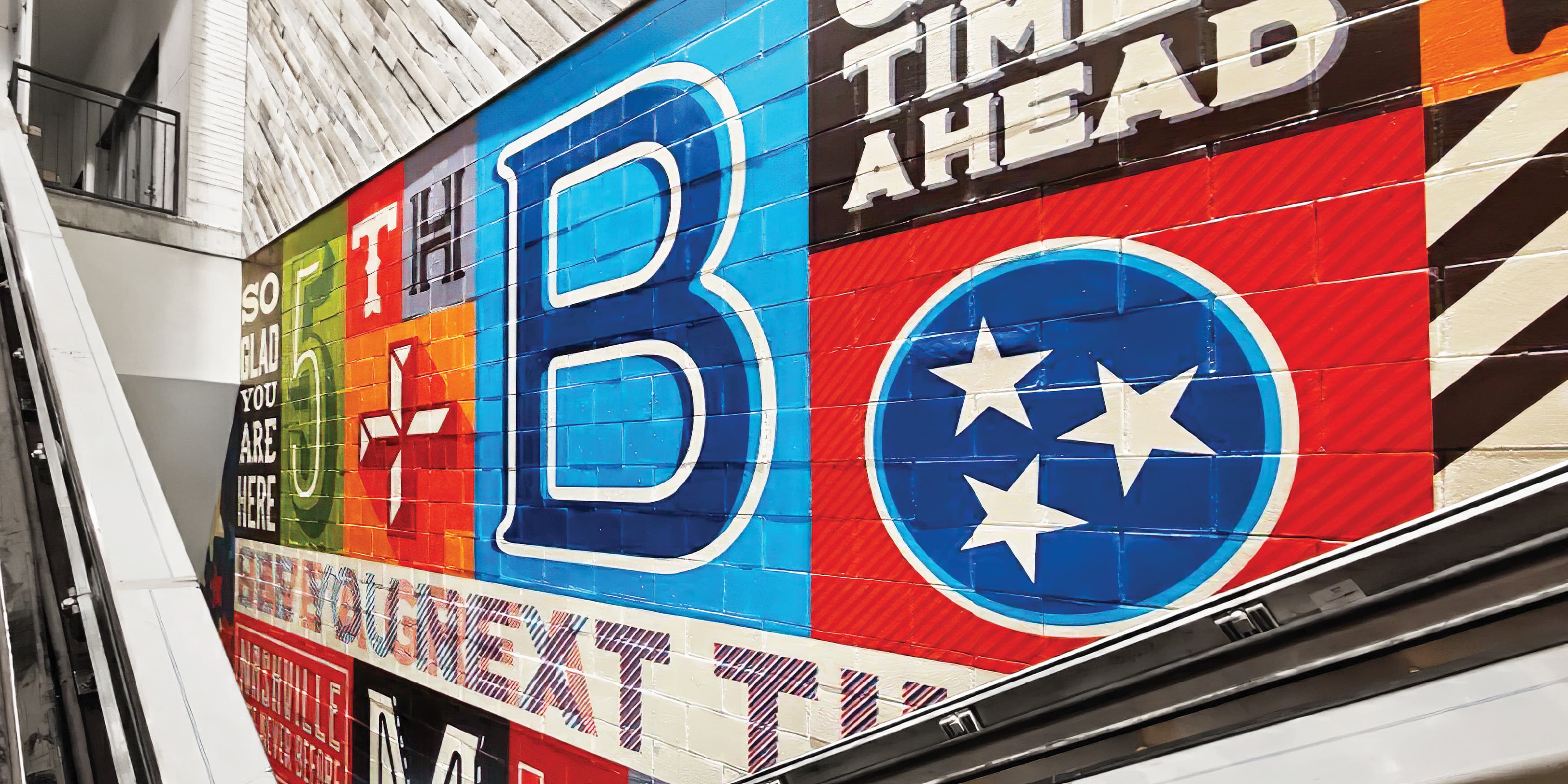 Red, blue, black, and green typography focused mural for a parking garage in Nashville, Tennessee. 