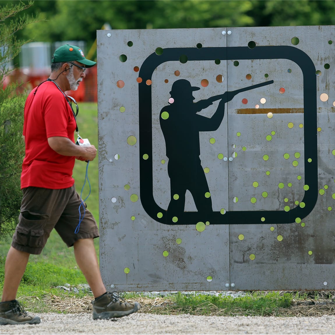 Large-scale perforated metal shooting sports activity sign with silhouette pictogram at Summit Bechtel Reserve, outdoor wayfinding and environmental graphic design by RSM Design