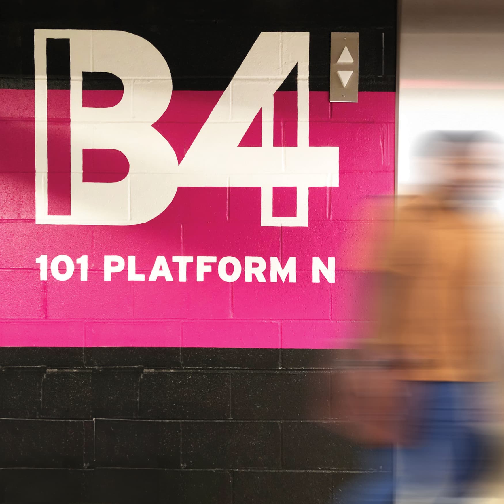 Colorful and geometric signage of B4 parking garage signage. Pink and black color blocked paint, designed by RSM Design. 