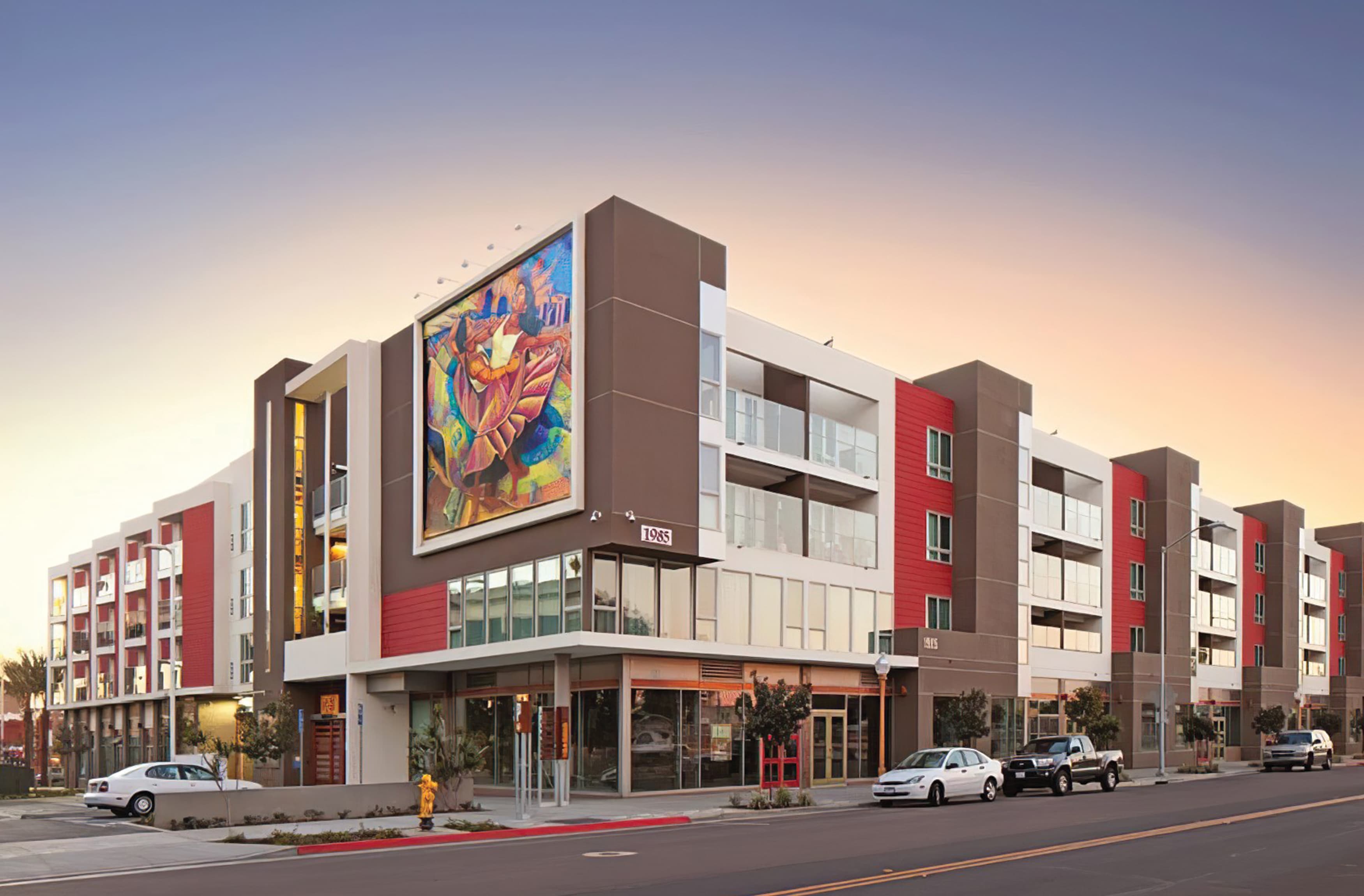 A photograph of a mixed-use residential and retail building located at Barrio Logan in San Diego, CA.