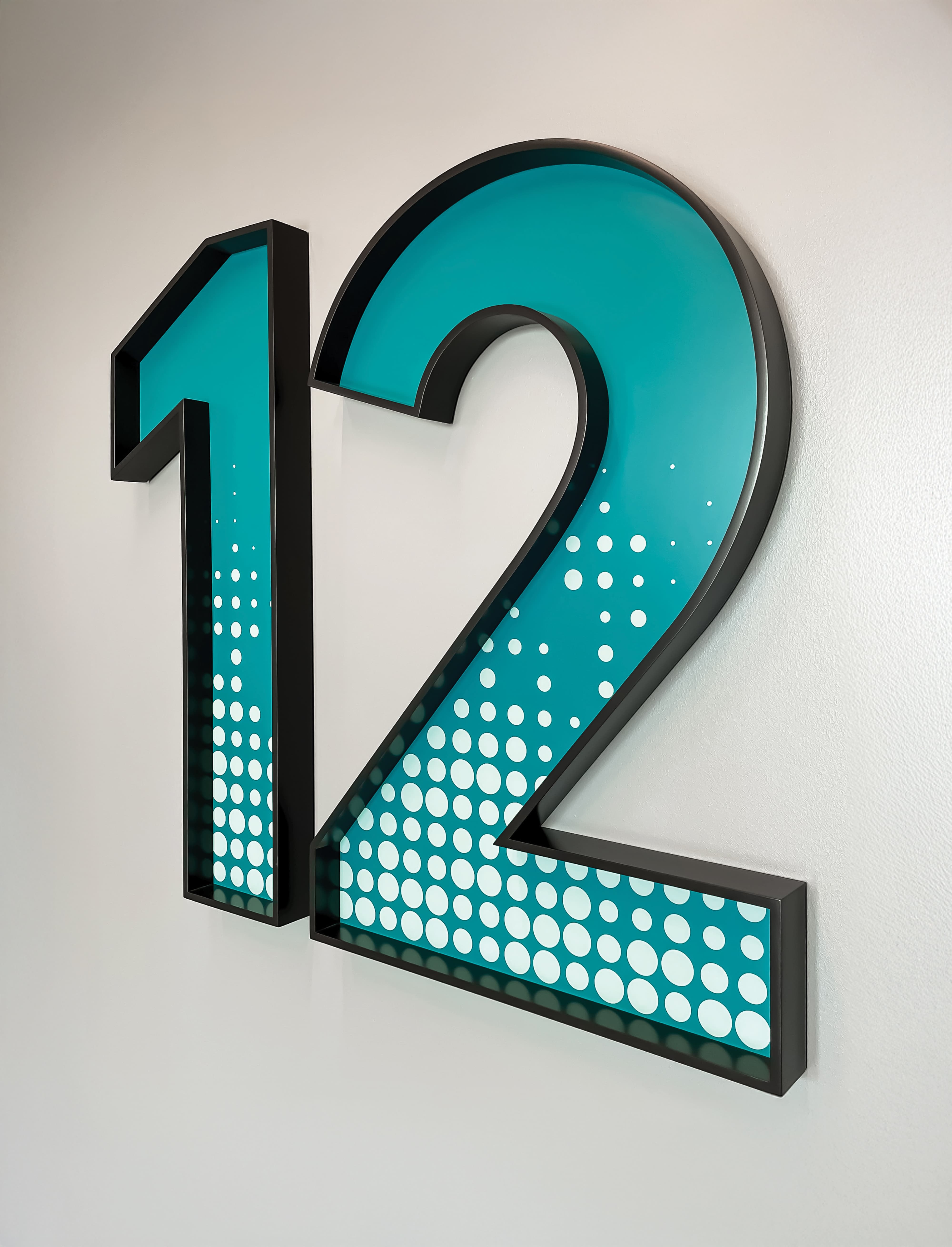 Dimensional “12” floor identification sign with layered graphics, showcasing environmental graphic design, signage systems, and intuitive wayfinding for healthcare, workplace, and mixed-use environments.