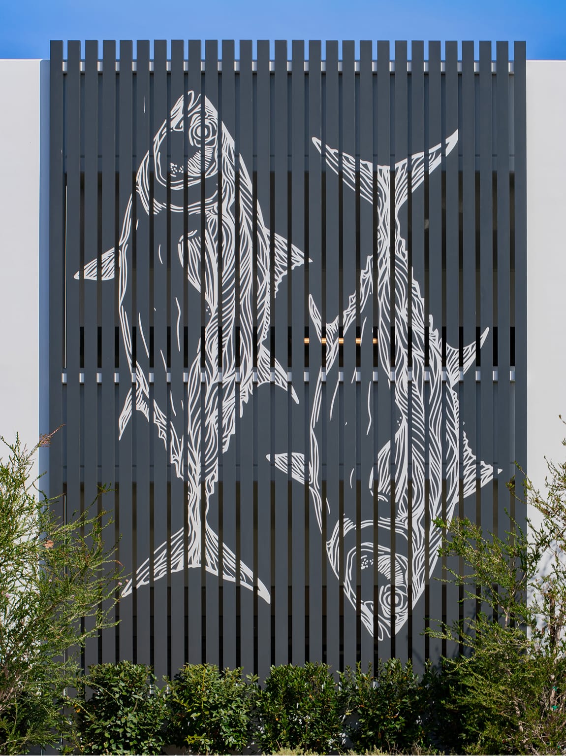 Dana Point Harbor parking structure facade with large-scale fish environmental graphics on slatted screen — environmental graphic design by RSM Design