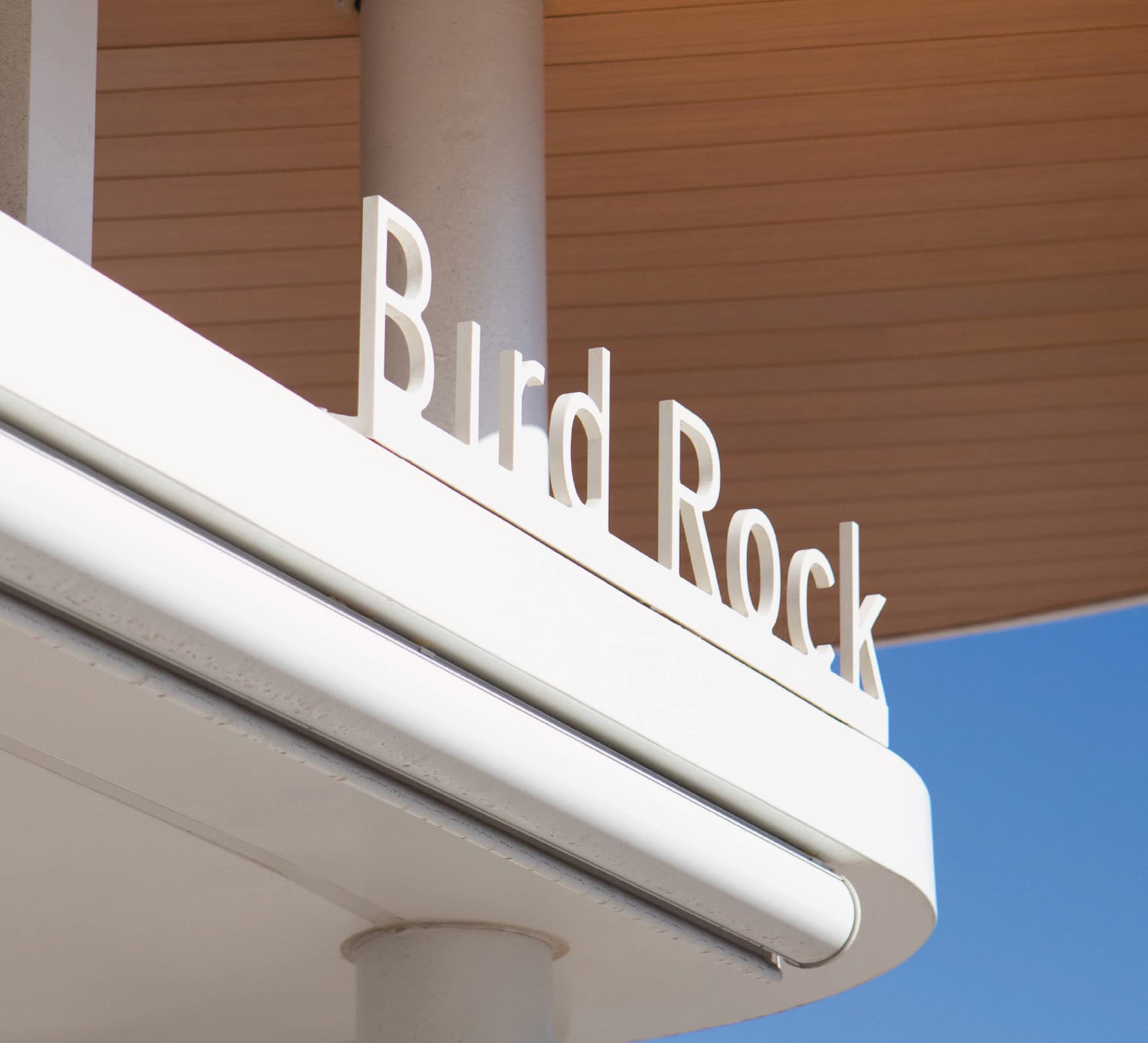 Bird Rock rooftop signage integrated into coastal retail architecture, showcasing environmental graphic design, identity signage, and wayfinding for a mixed-use retail and hospitality destination by RSM Design