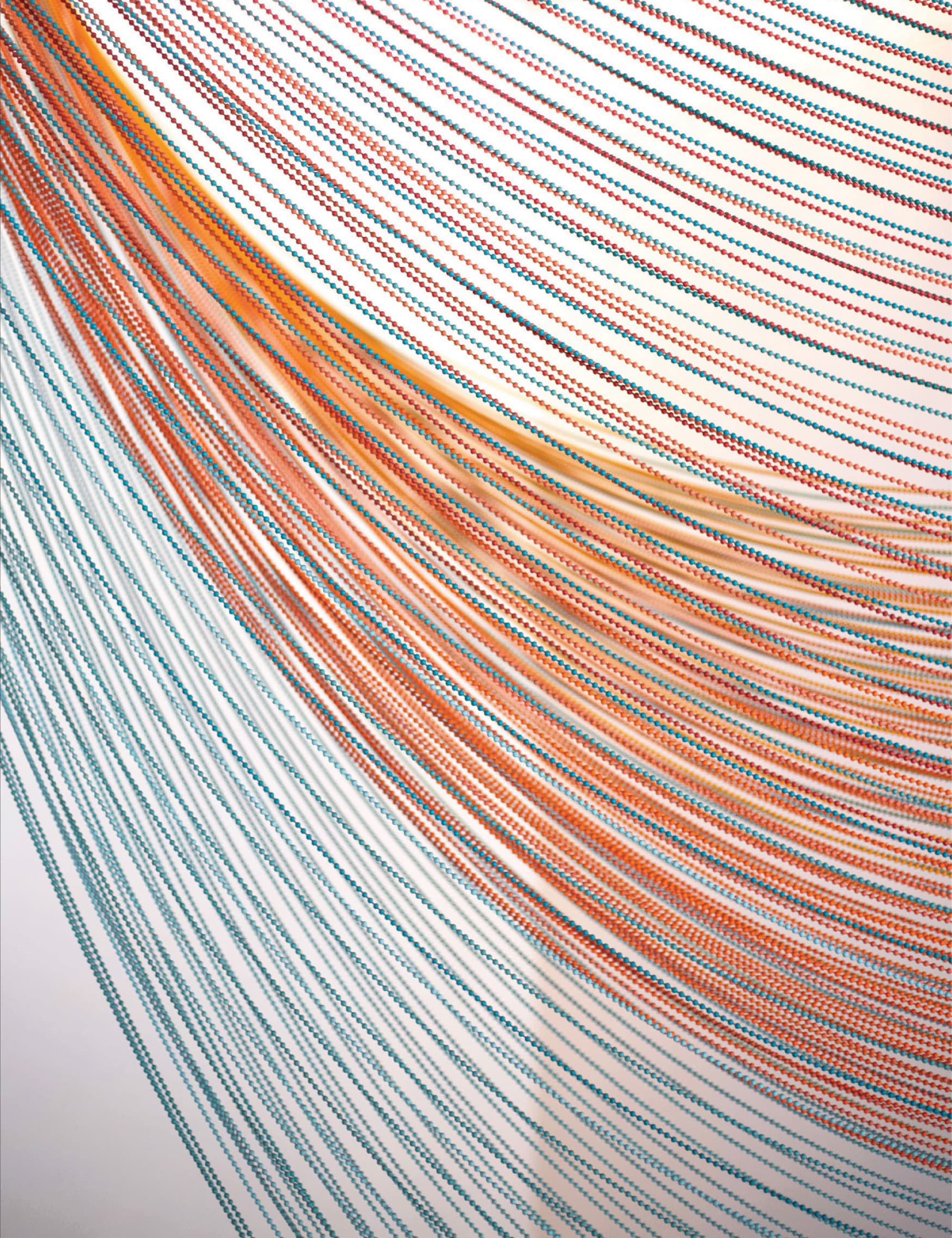 Close-up of hundreds of hanging beaded strings in teal, orange, and red, curving diagonally to form a flowing wave-like pattern.
