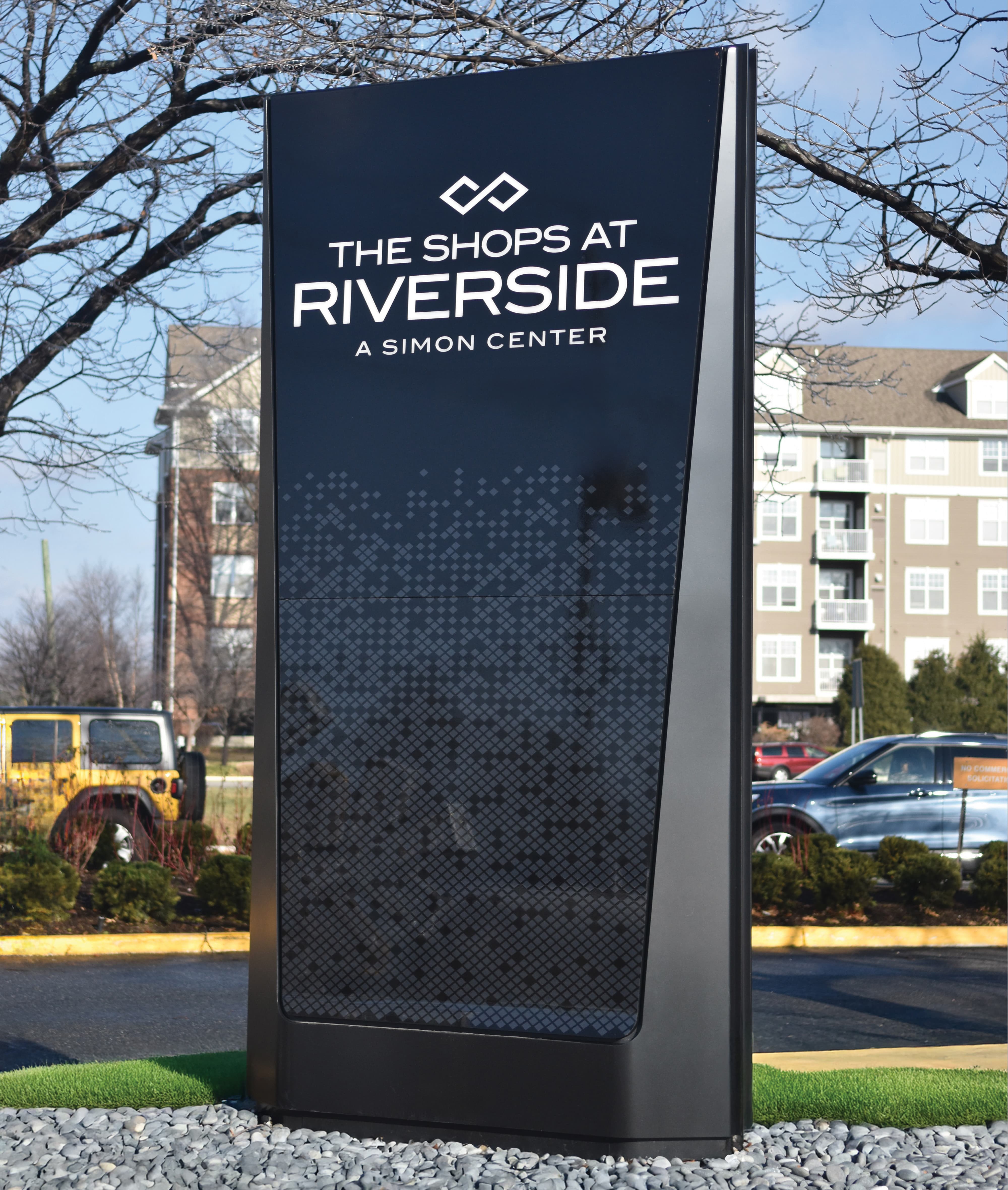 Exterior monument signage for The Shops at Riverside, a Simon retail center, showcasing environmental graphic design, wayfinding, and branded placemaking that enhance navigation and identity within a mixed-use retail and commercial environment.