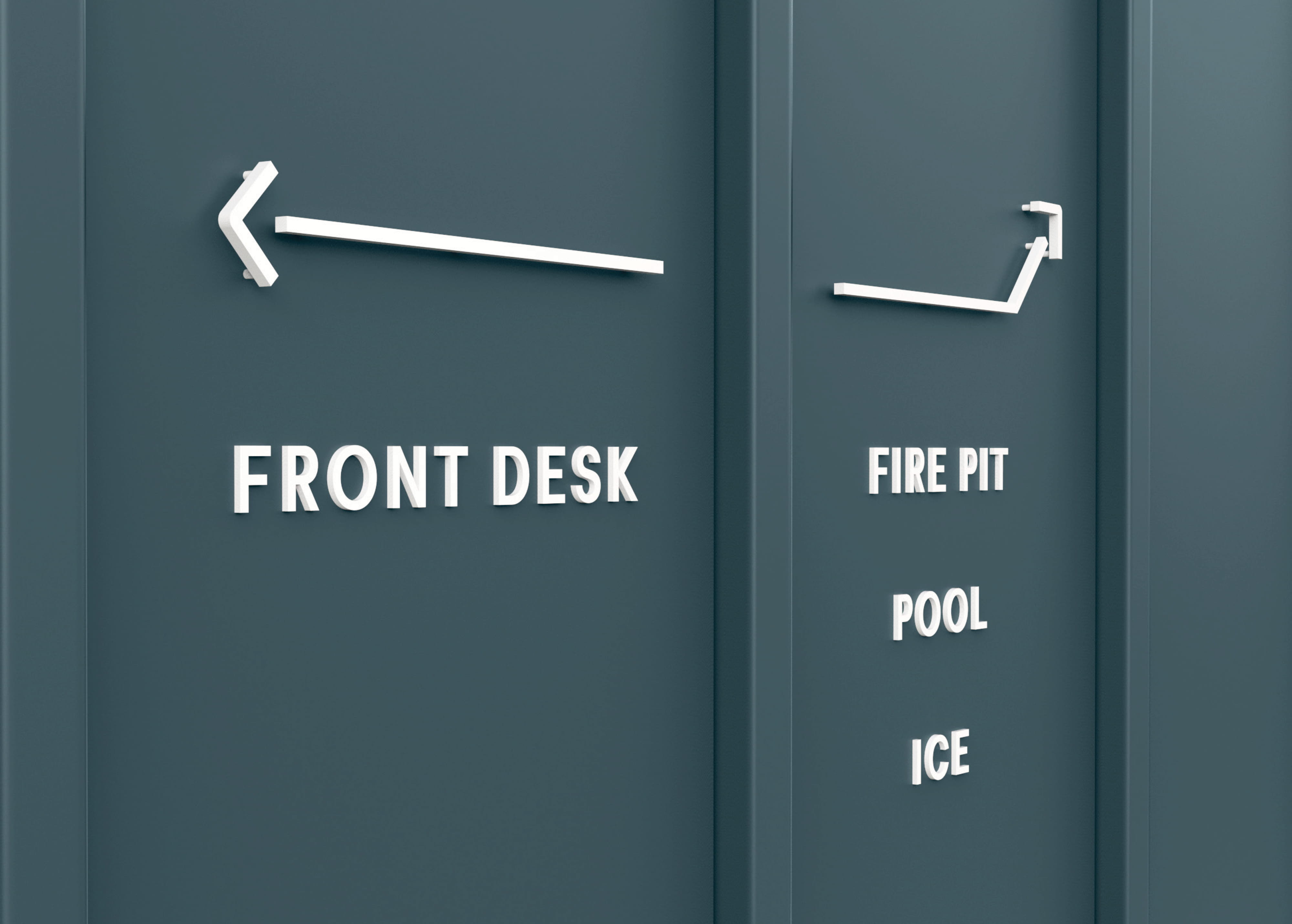 Close-up of dimensional white wayfinding letters and custom arrow hardware mounted on a teal exterior wall directing guests to the Front Desk, Fire Pit, Pool, and Ice at Trailborn Rocky Mountains Outpost, showcasing specialty graphics and signage design for a hospitality environment by RSM Design.