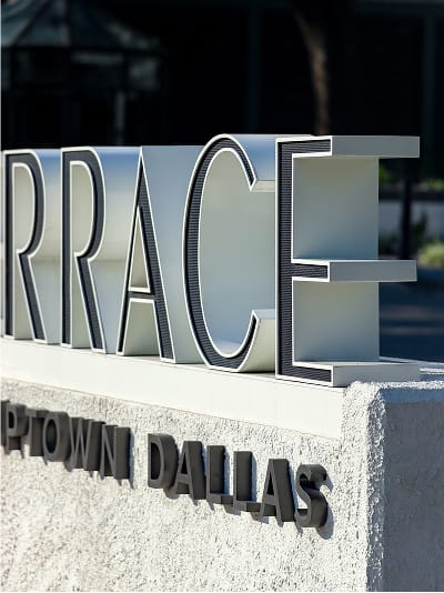 Detail of dimensional metal letterforms on the Maple Terrace monument sign at the property entrance - environmental graphic design by RSM Design
