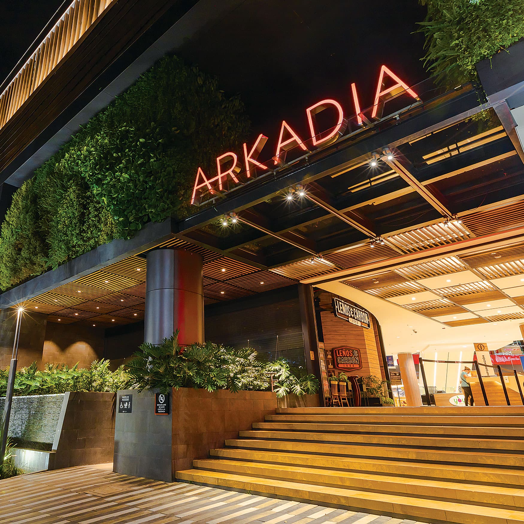 Night time view of Arkadia entrance signage at mall.