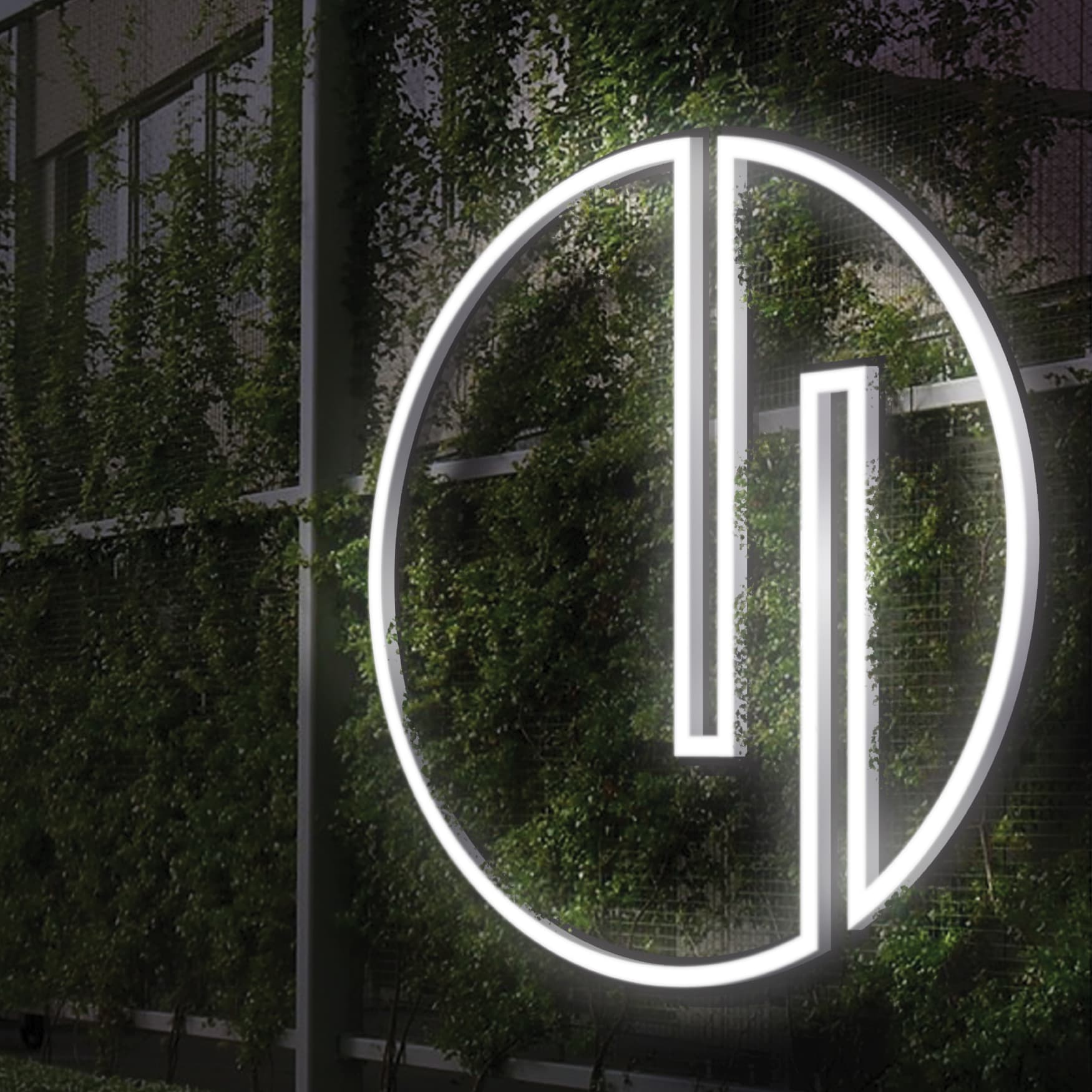 Close up image of the details of the Nashville Yards logo, mounted on a landscaped wall. 