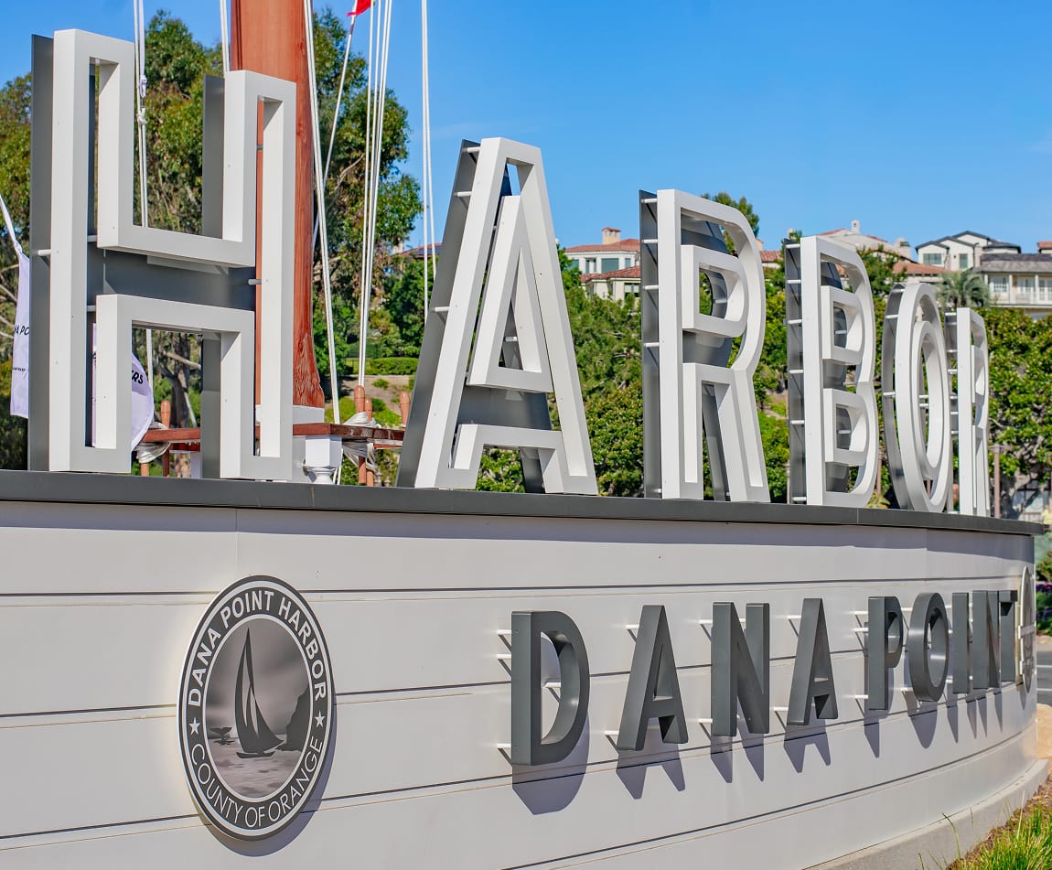Dana Point Harbor gateway monument close-up with large-scale dimensional lettering and County of Orange seal — environmental graphic design by RSM Design