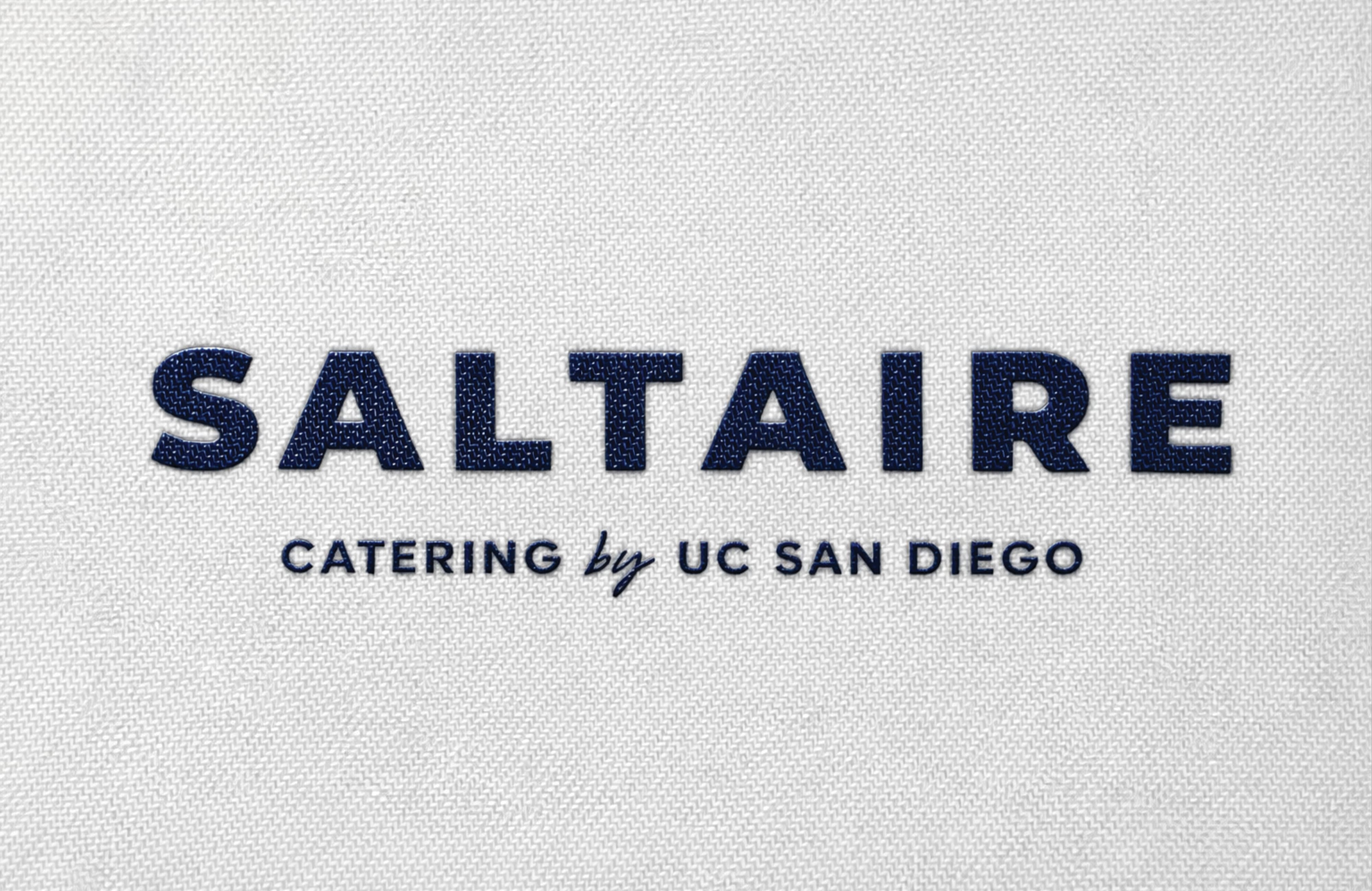Saltaire Catering by UC San Diego brand logo with navy blue textured lettering on a light gray background, showcasing visual identity and branding design for a food and beverage and education market client by RSM Design.
