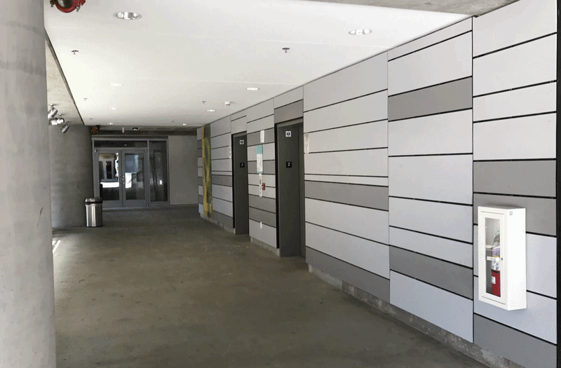 Parking structure elevator lobby at Runway Playa Vista in Los Angeles featuring integrated architectural graphics and wayfinding design by RSM Design.