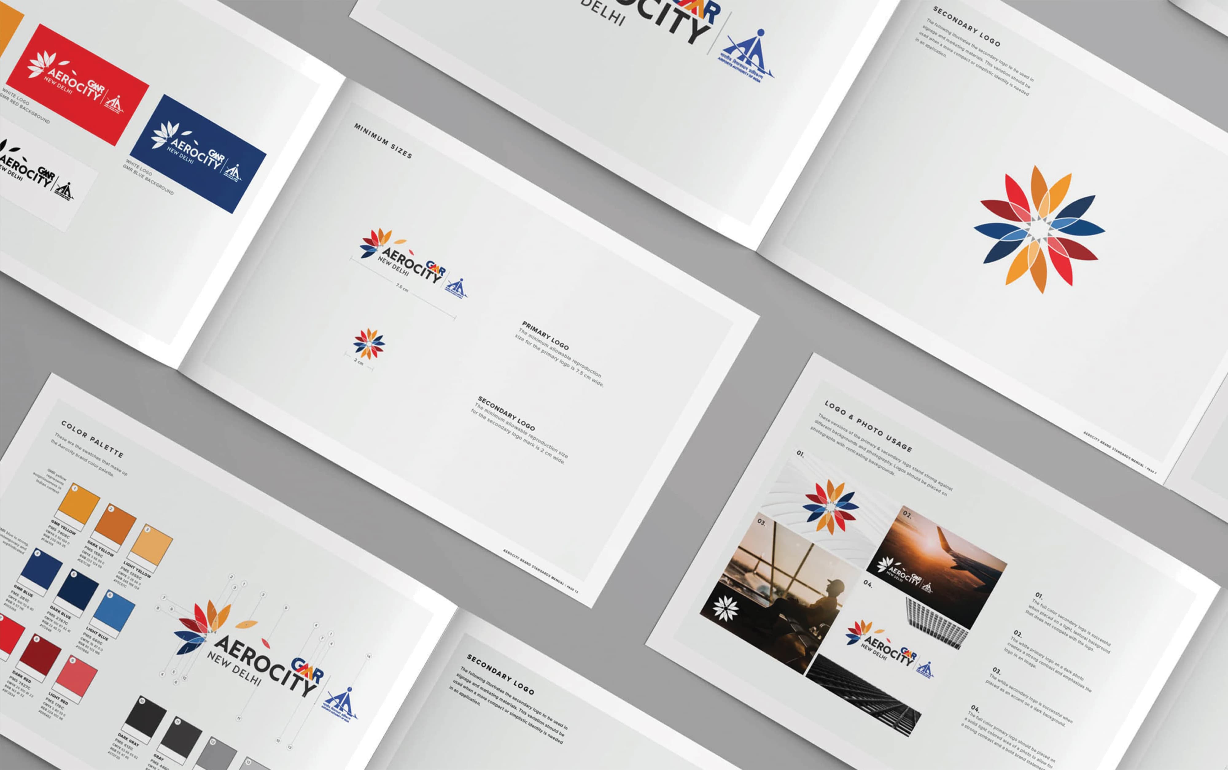 GMR Aerocity New Delhi brand standards manual spread pages showing primary and secondary logo variations, color palette, minimum size guidelines, and logo and photo usage rules featuring the multicolored lotus flower brand mark — RSM Design branding and visual identity, print and digital collateral, and environmental graphic design for mixed-use, transit, and international destinations.