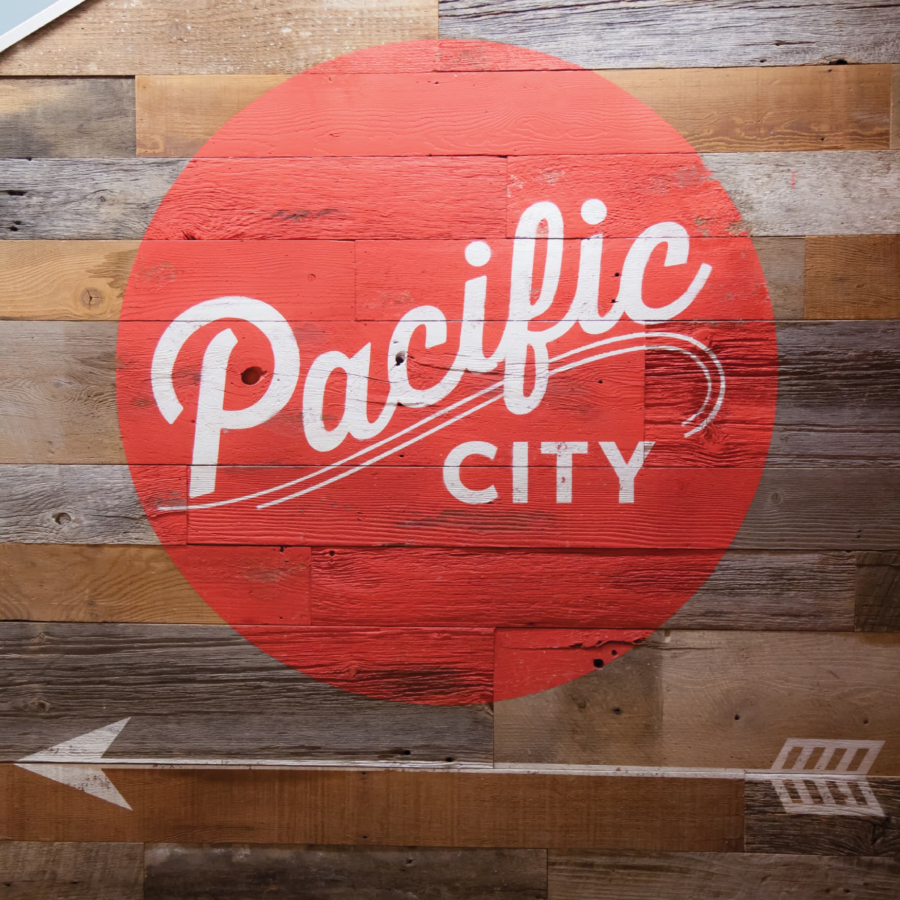 Red circle logo mural of Pacific City in Huntington Beach, CA. 