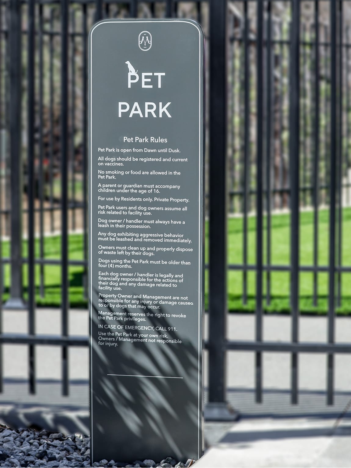 Pet Park pylon sign with dog icon and posted rules at the fenced dog run at Maple Terrace - environmental graphic design by RSM Design