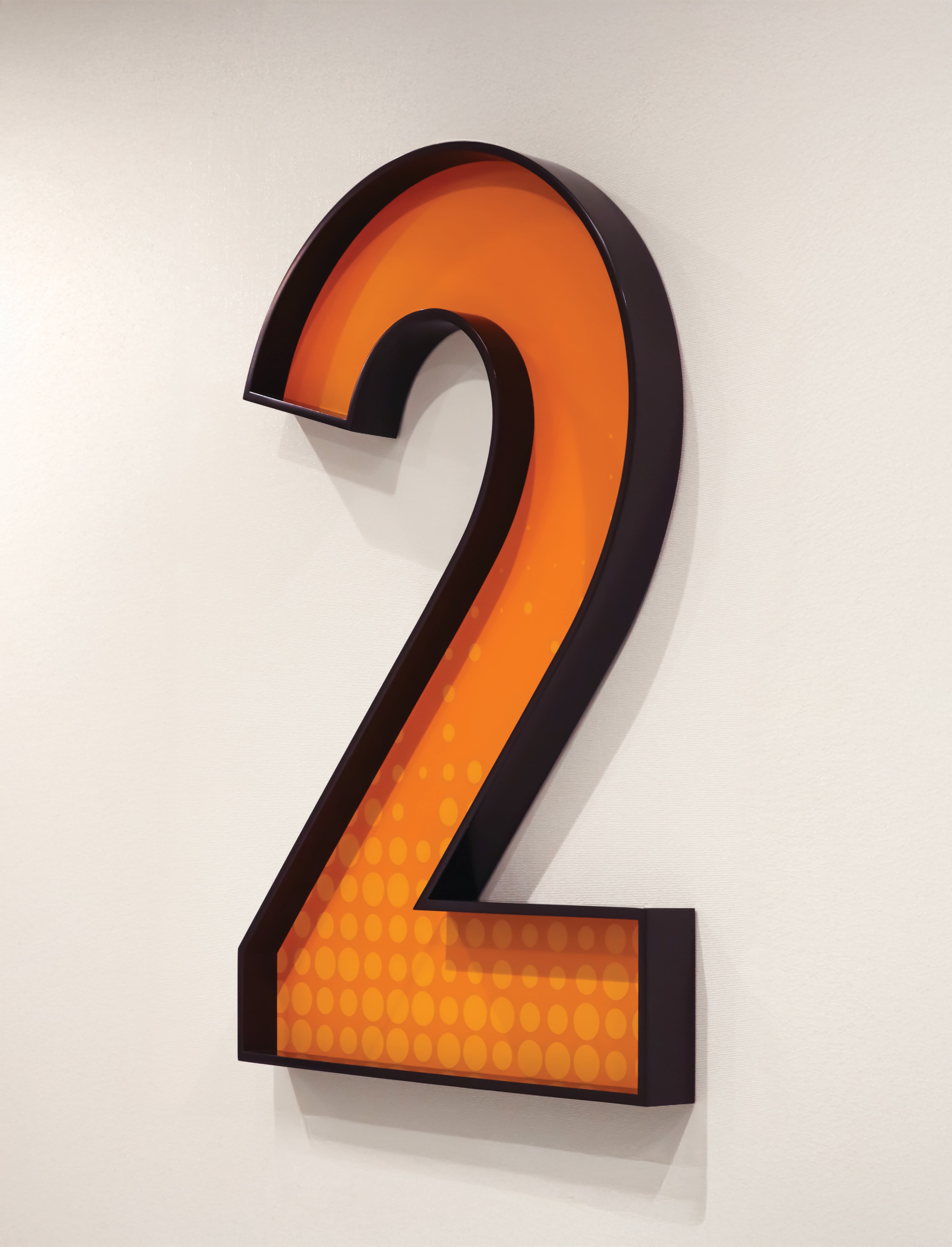 Dimensional “2” floor identification sign with integrated lighting and graphic pattern, showcasing environmental graphic design, signage systems, and intuitive wayfinding for healthcare, workplace, and mixed-use environments.