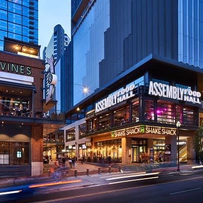 Assembly Food Hall signage at Fifth + Broadway integrated into the building façade, creating a prominent and recognizable destination within the district.
