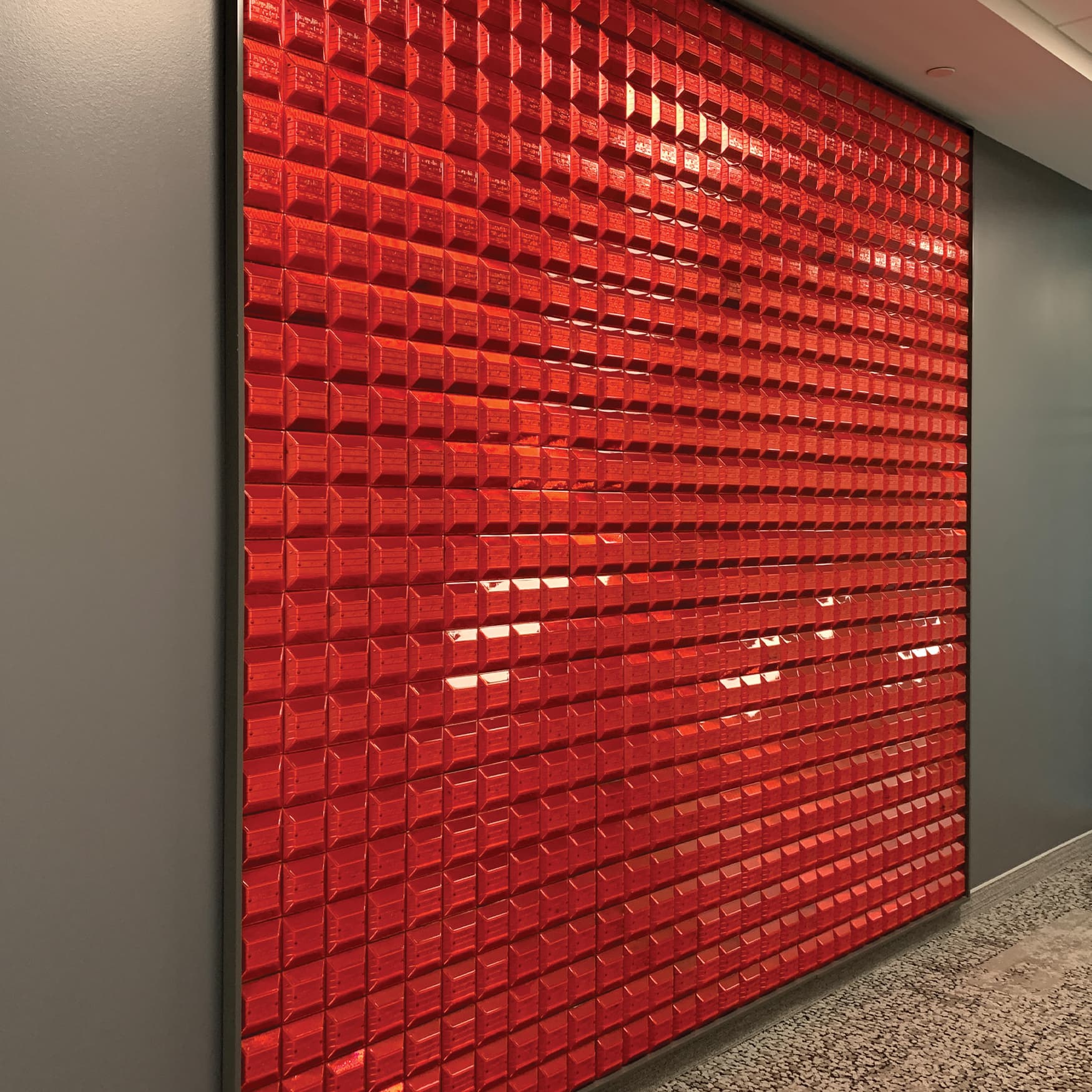 Speciality art mural by RSM Design for JMFE Headquarters consisting of red speed bumps for office workplace design.