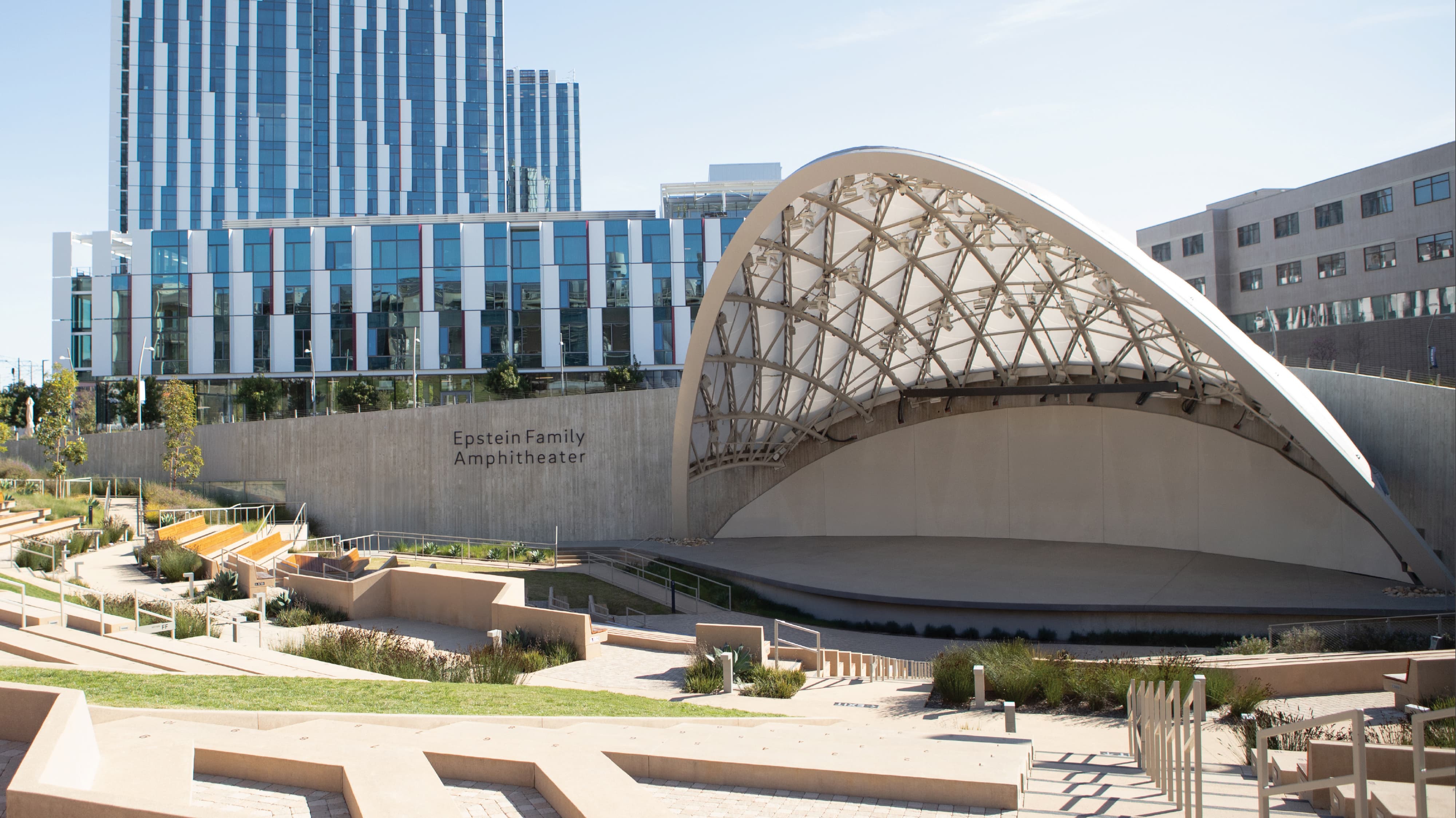 Epstein Family Amphitheater with contemporary canopy structure and tiered seating, showcasing experiential graphic design, wayfinding, and placemaking for a mixed-use campus and cultural destination by RSM Design