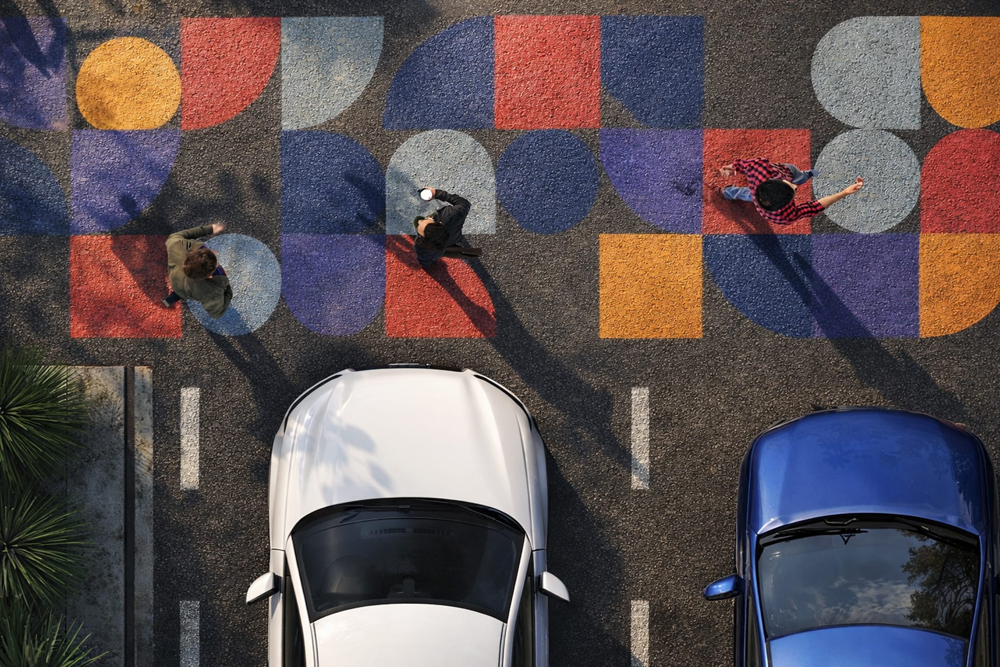 RSM Design branded pavement mural and crosswalk art for HUB RTP — aerial view of colorful geometric street graphics with bold shapes in red, orange, blue, and purple creating an experiential pedestrian environment at Research Triangle Park, Durham NC