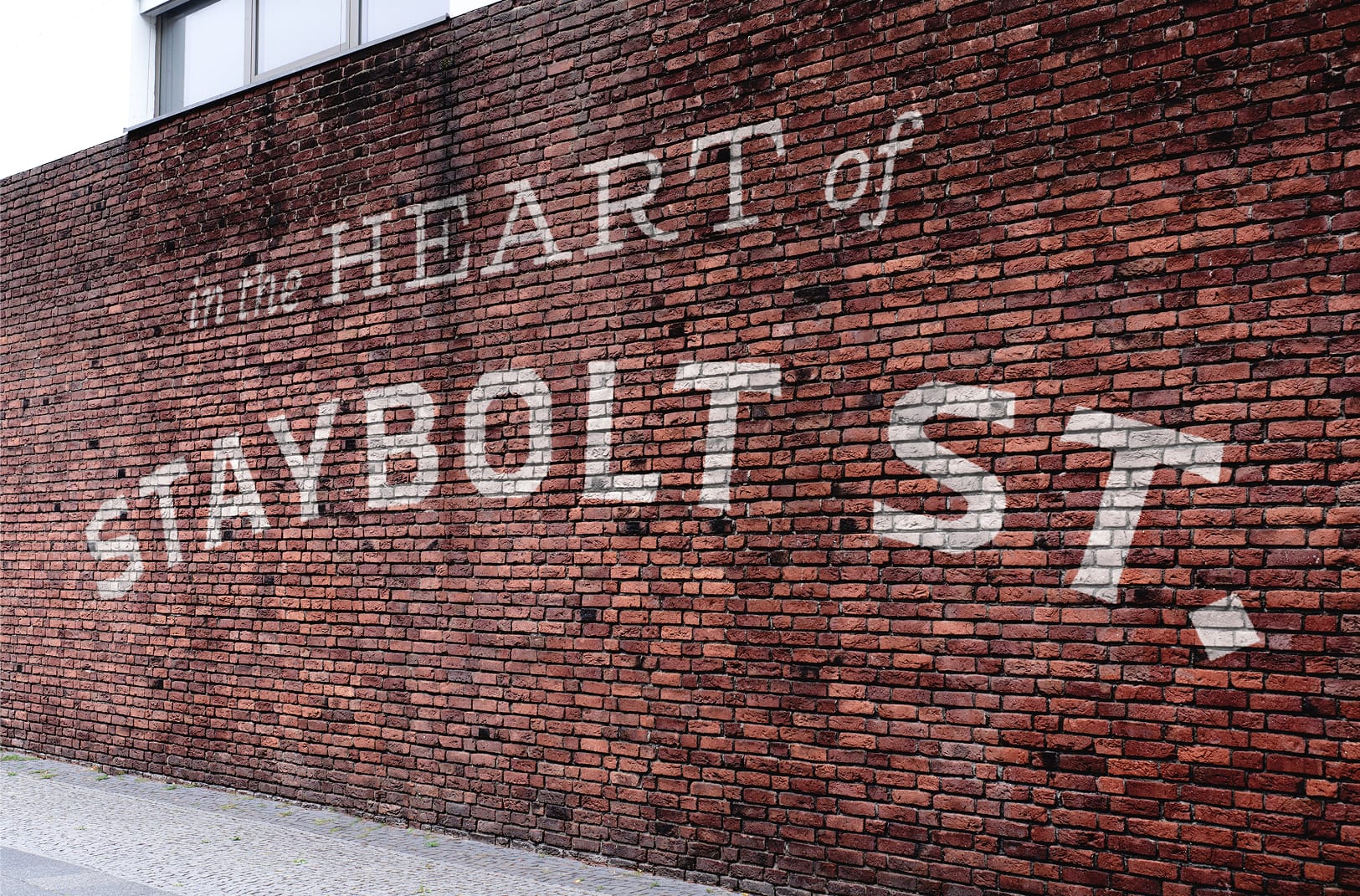 Staybolt Street large-scale ghost sign mural on brick facade in Mansfield, Texas — environmental graphic design by RSM Design