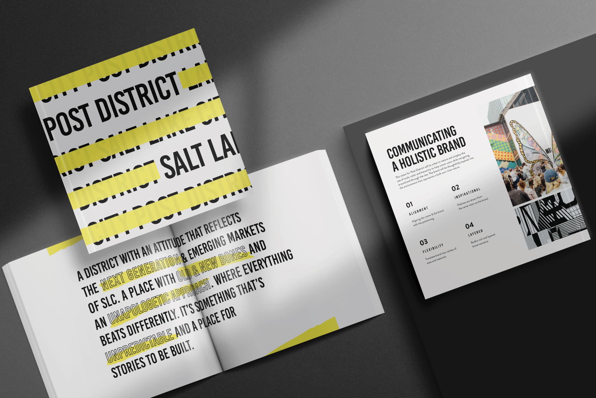 Brand guidelines booklet for Post District in Salt Lake City displaying a bold typographic cover, a brand vision narrative spread, and a 'Communicating a Holistic Brand' framework page outlining alignment, inspiration, flexibility, and layered storytelling — showcasing RSM Design's branding and visual identity, naming, vision, and strategy work for a mixed-use residential community.