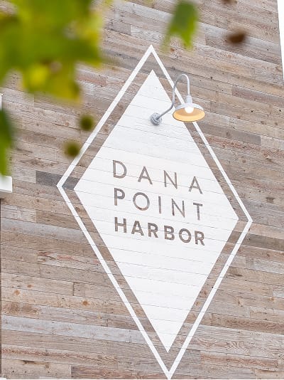 Dana Point Harbor diamond identity mark on reclaimed wood facade — environmental graphic design by RSM Design