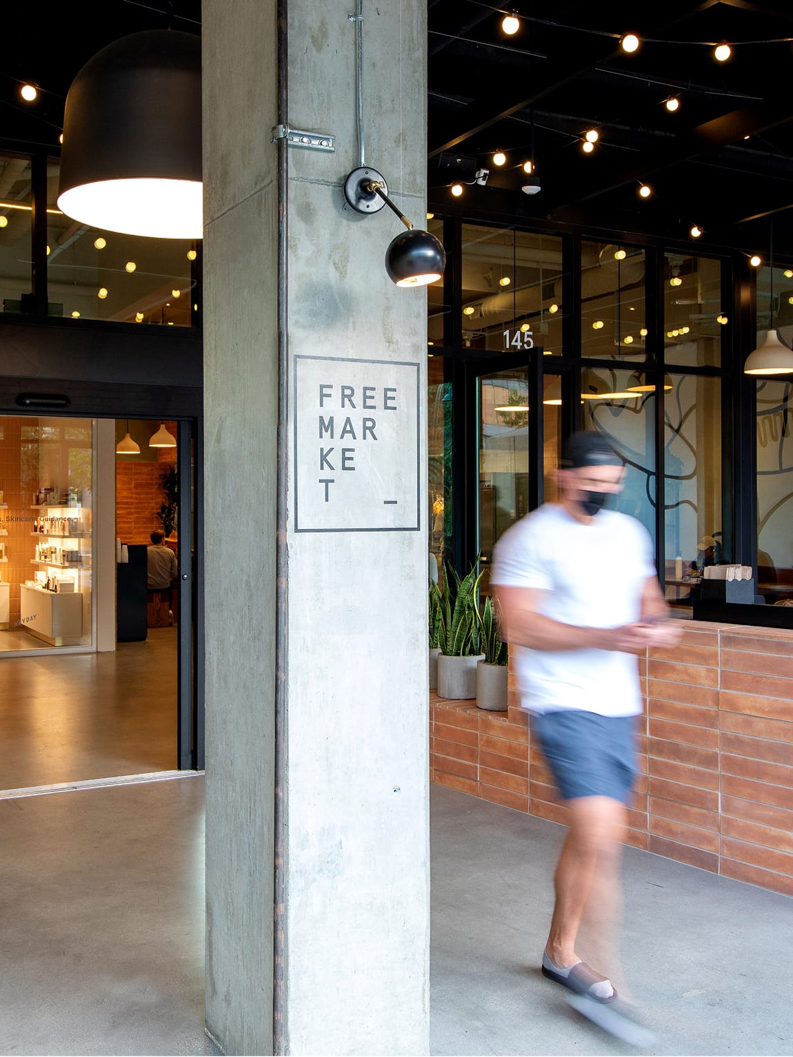 Free Market storefront signage at Runway Playa Vista retail district in Los Angeles, part of the environmental graphics and placemaking design by RSM Design.