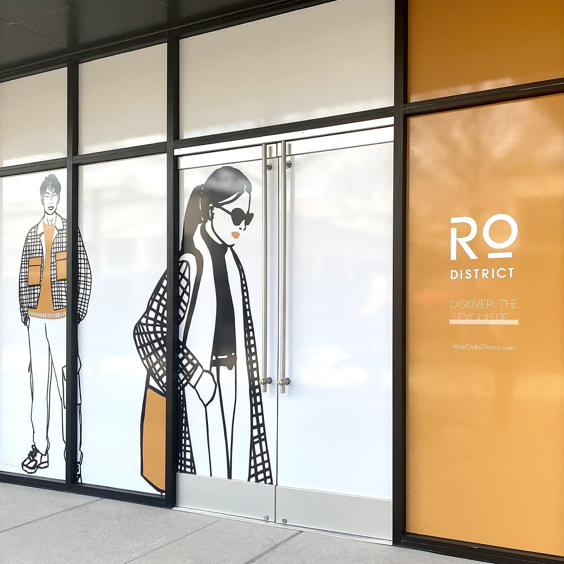 River Oaks District Houston storefront window graphics with illustrated fashion figures in orange, environmental graphic design by RSM Design