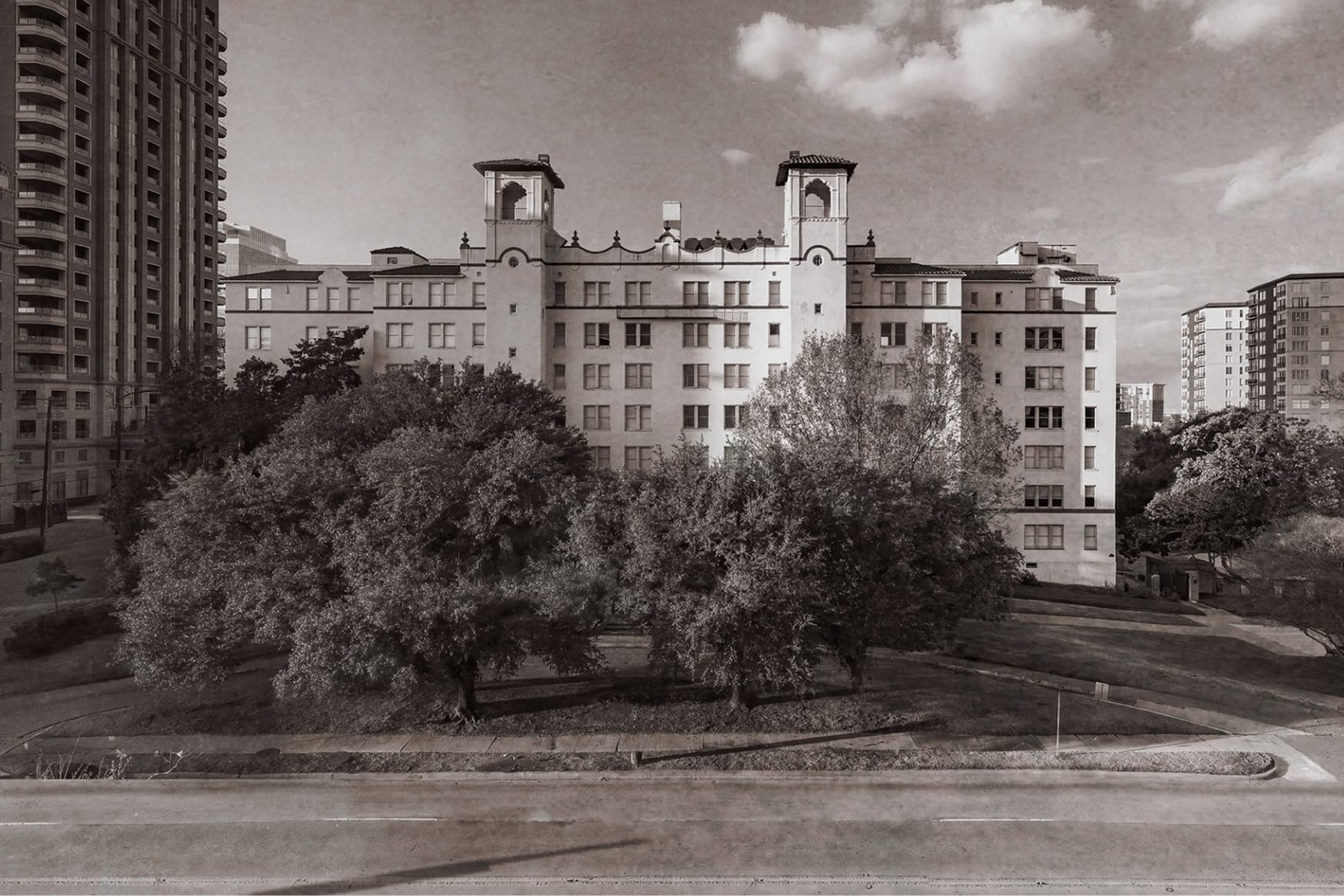 Historic black-and-white photograph of the original Maple Terrace apartment building in Uptown Dallas, showing its twin towers and Mediterranean Revival architecture