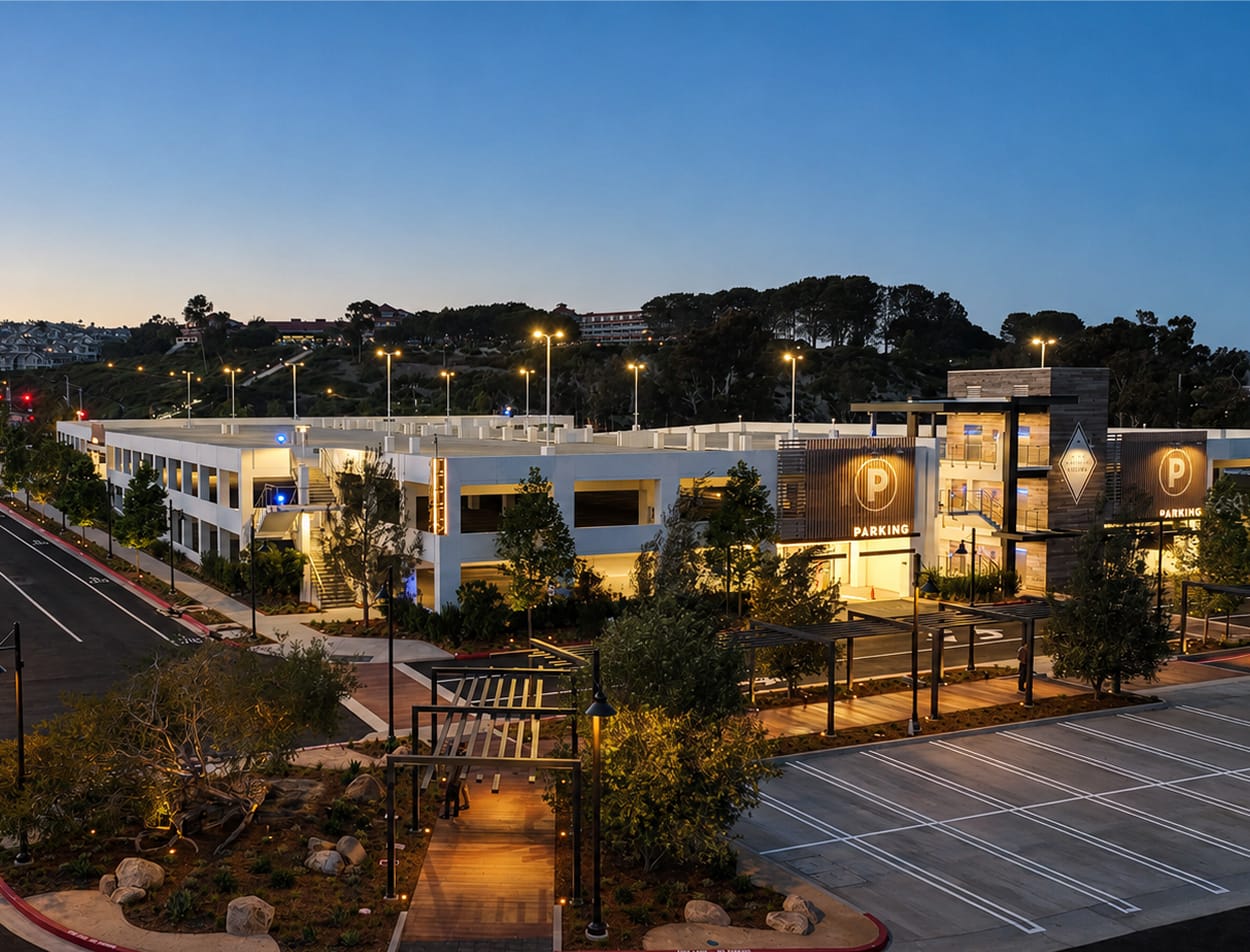 Dana Point Harbor parking structure at dusk with illuminated parking identity signage and diamond logo mark — wayfinding and environmental graphic design by RSM Design